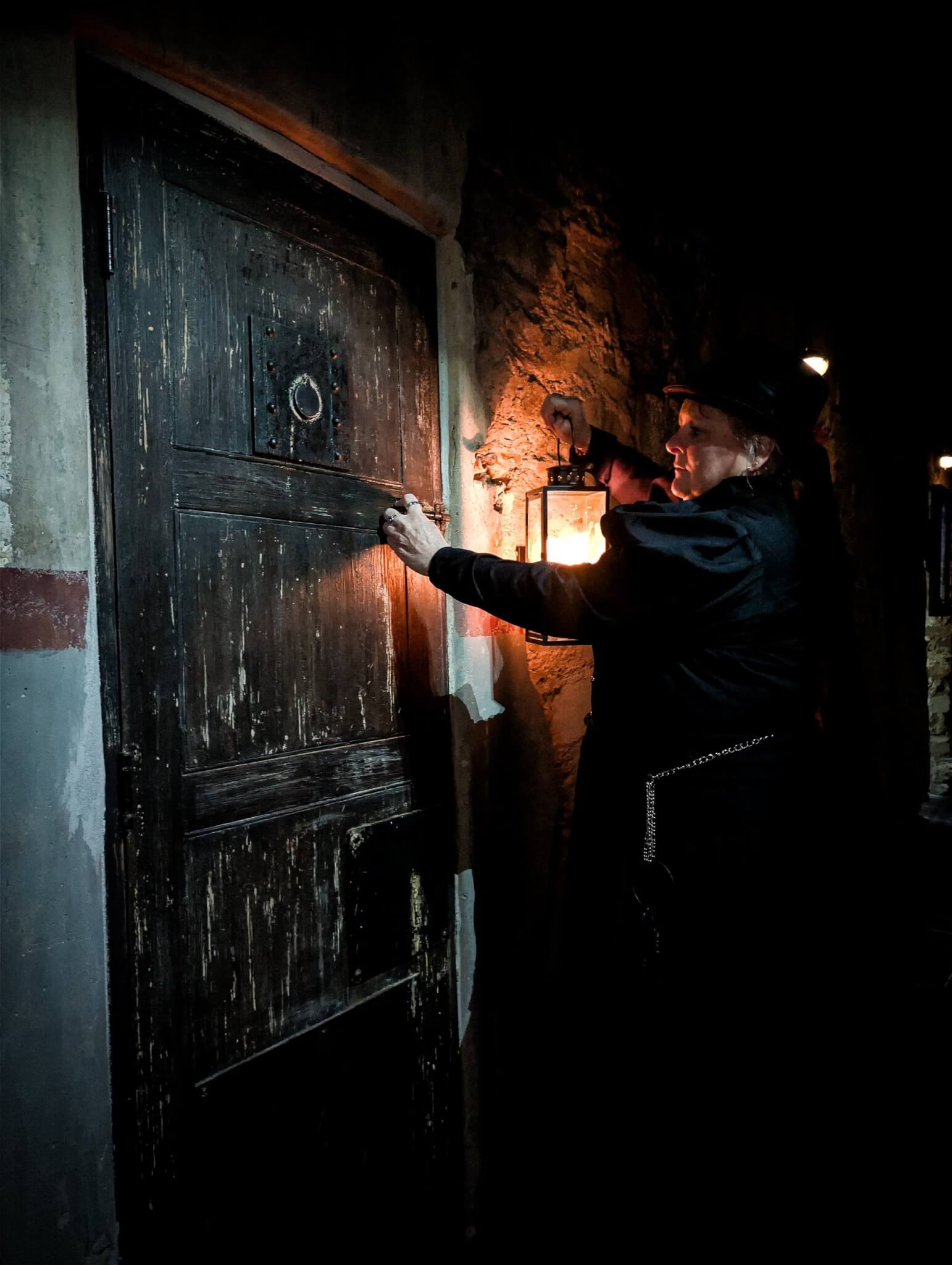 Ghost Walk guide at a heavy cell door at Bodmin Jail