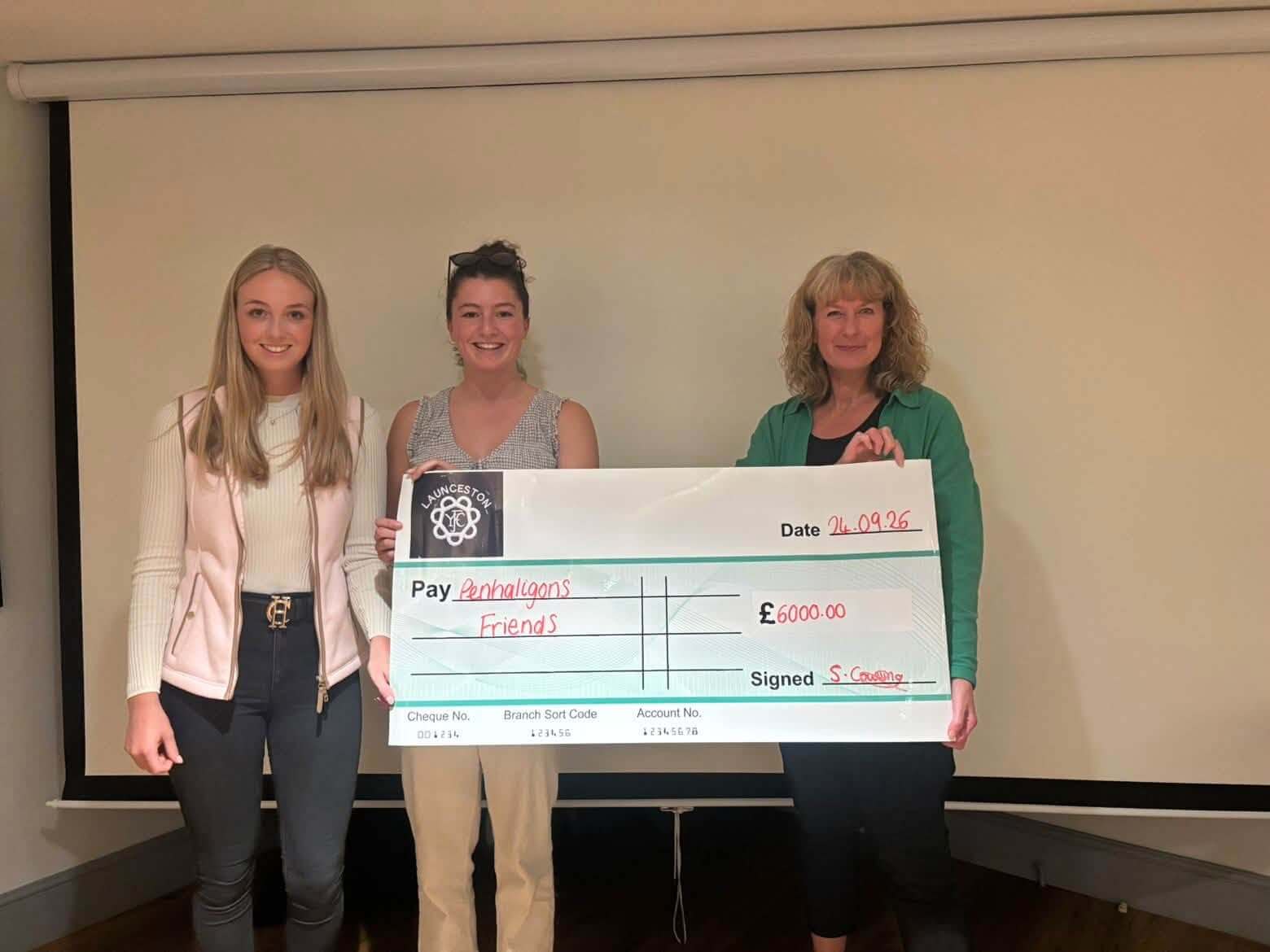Launceston Young Farmers Club members and Julie Parker holding a £6,000 cheque for Penhaligon's Friends