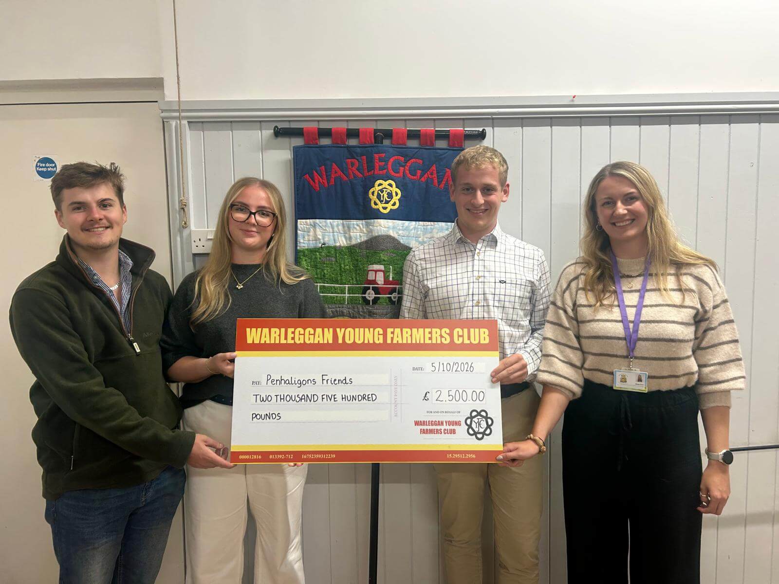 Warleggan Young Farmers Club members holding a £2,500 cheque for Penhaligon's Friends