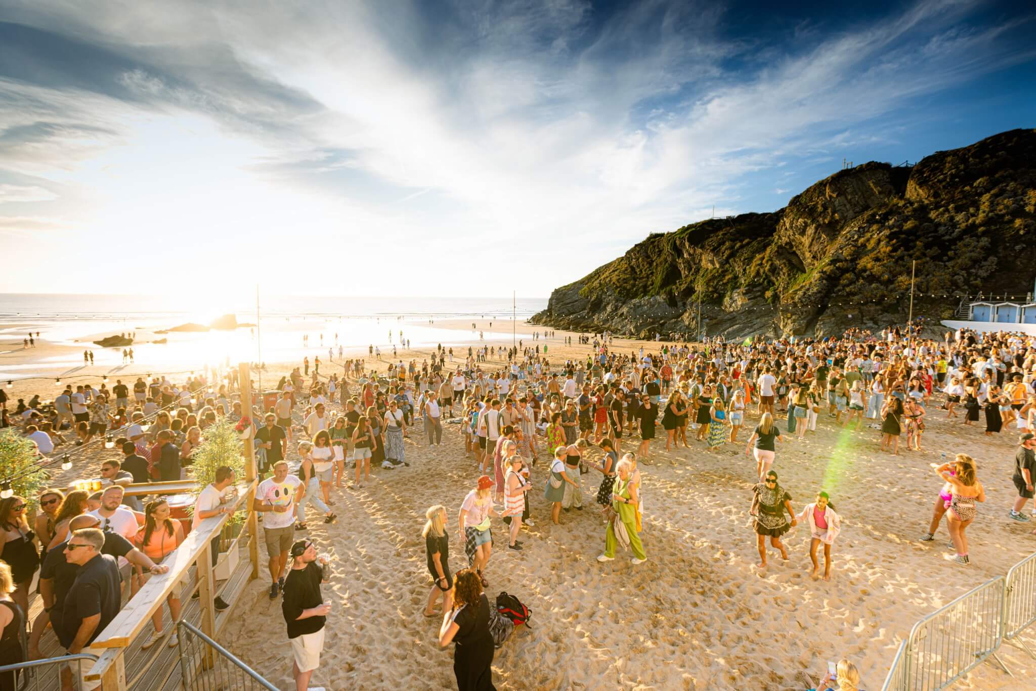 Crowd dancing on the sand at Lusty Glaze