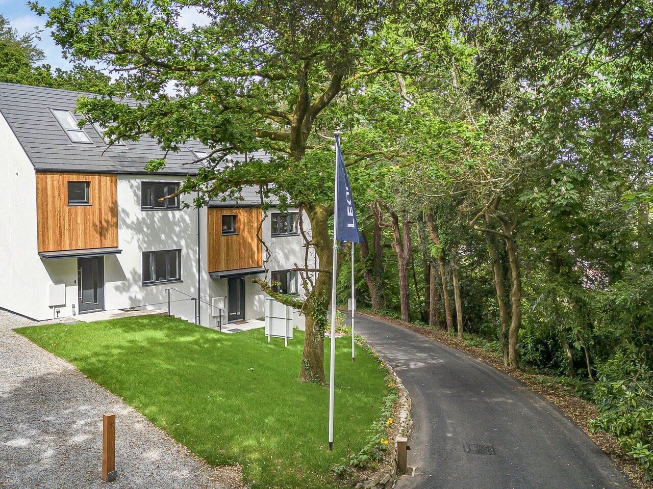 New homes beside a tree-lined lane at the Roselyon development in Par