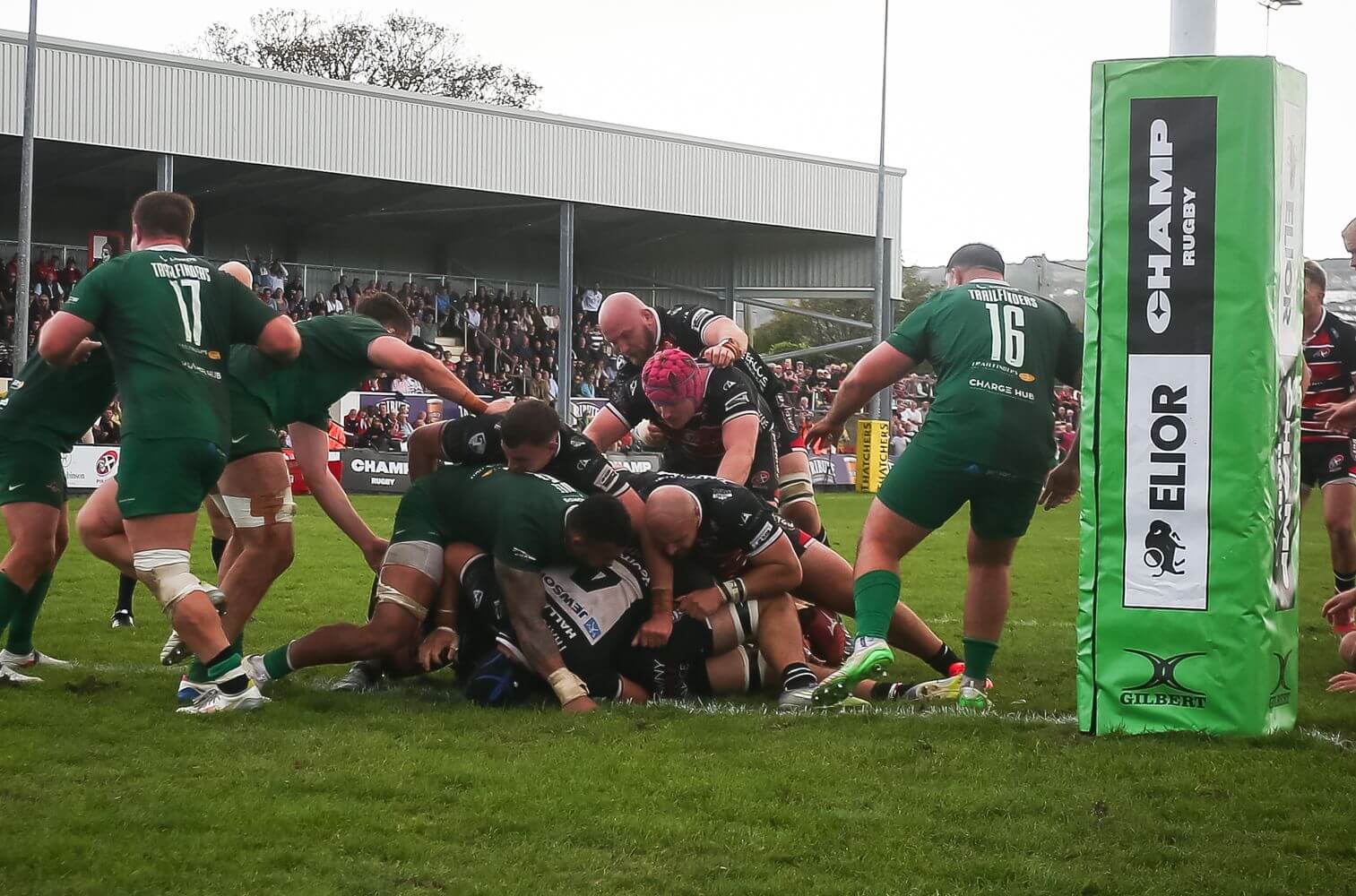 Cornish Pirates and Ealing Trailfinders forwards in a pile near the try line at the Mennaye Field