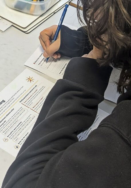 A student filling in a worksheet during the Naked Solar session