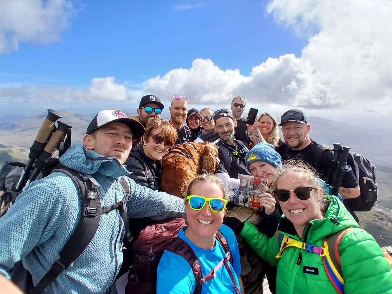 Team selfie on the summit of Snowdon under blue skies