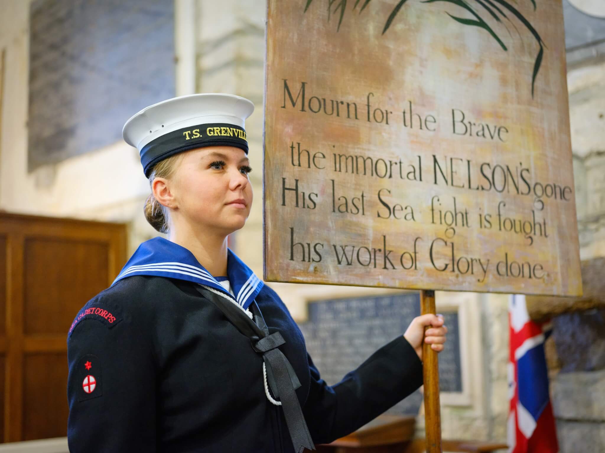 Sea Cadet holding the replica Nelson Banner inside Madron Parish Church