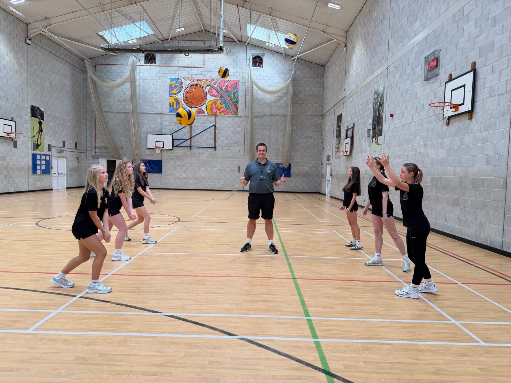 Pool Academy students practising volleyball with Matt Rogers