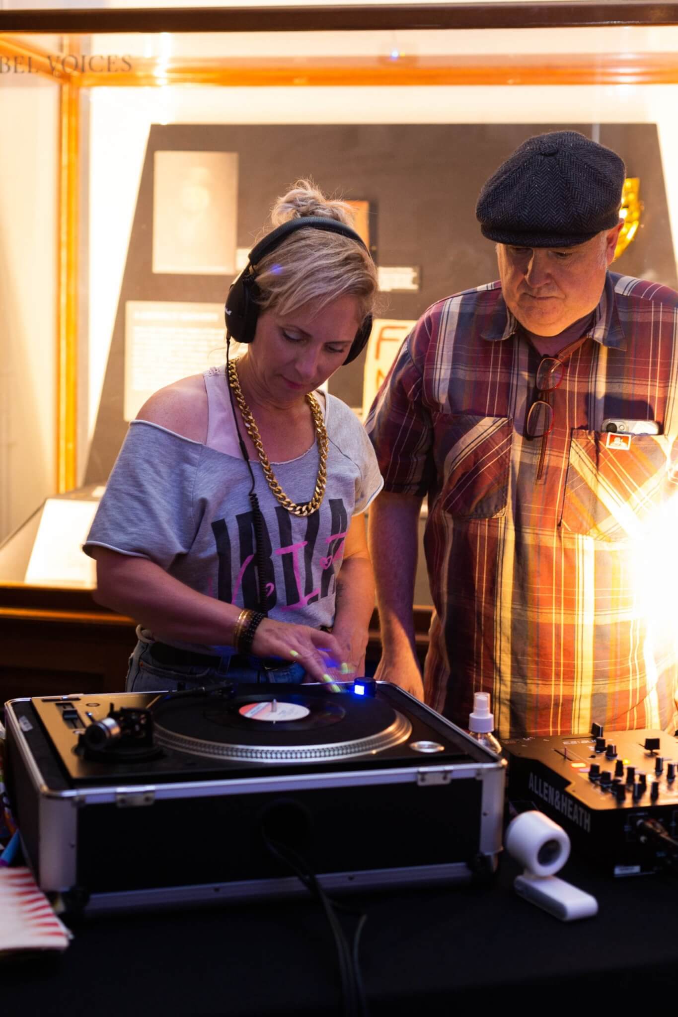 Two people at a record deck inside the museum