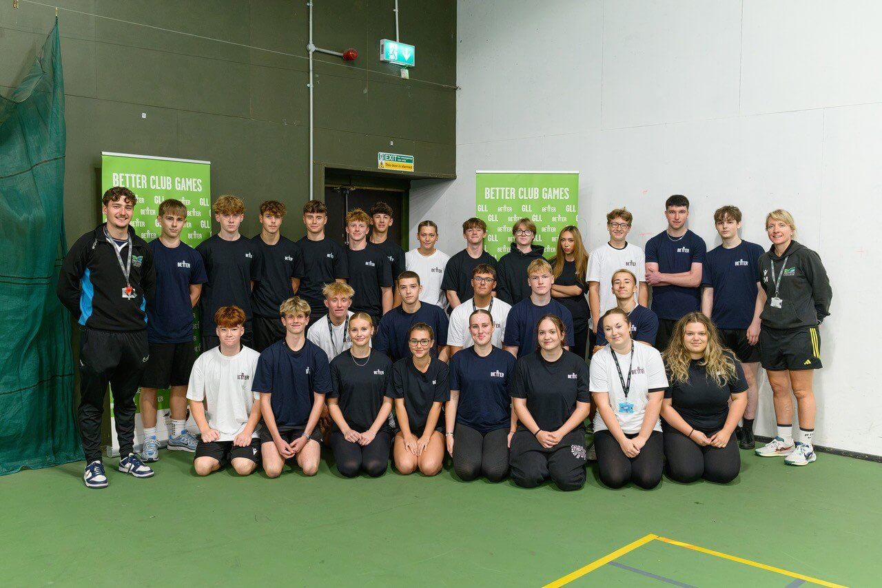 Group of young helpers in front of Better Club Games banners