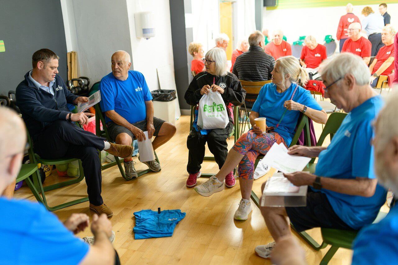Blue team members sitting in a circle between matches