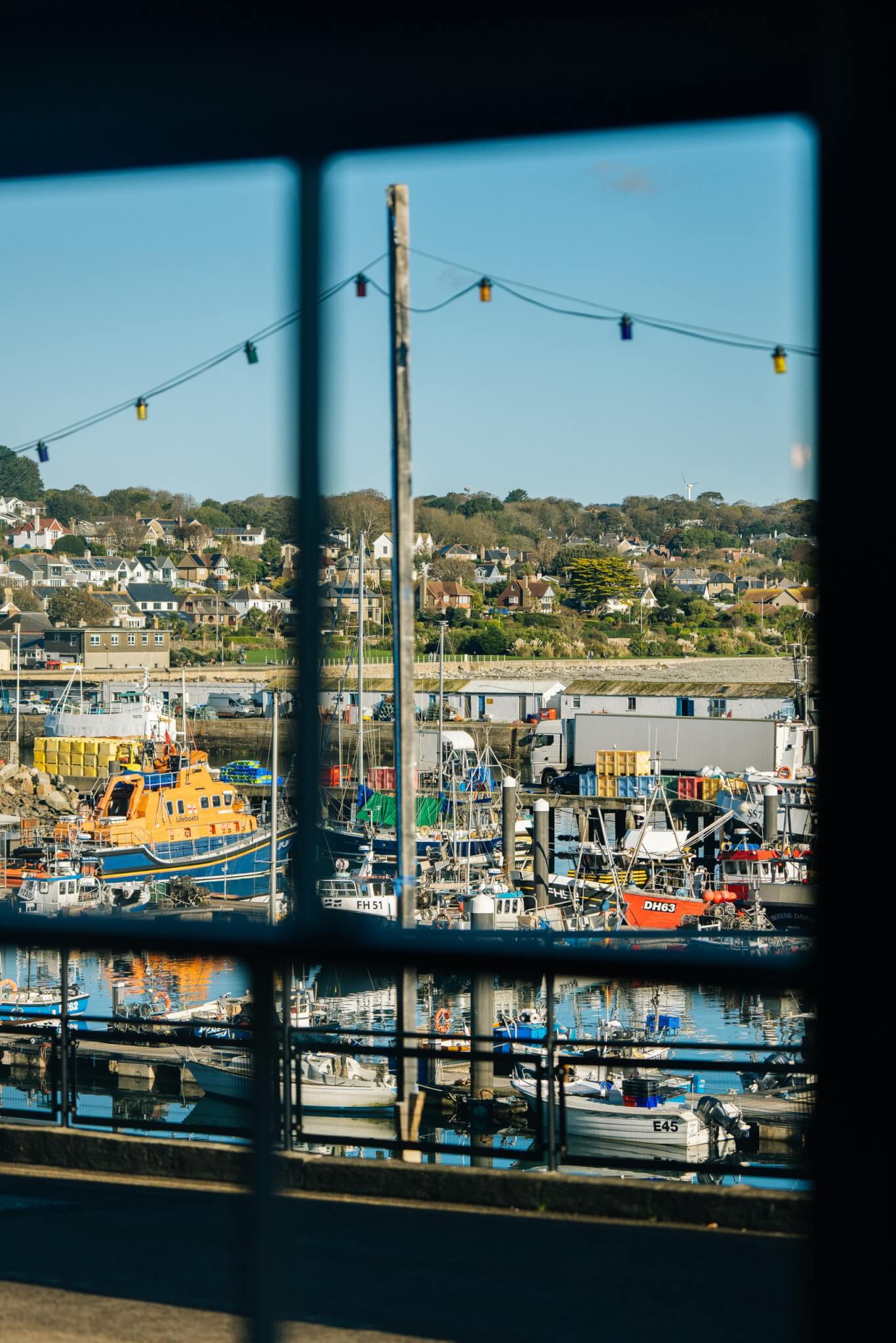 View of Newlyn harbour through a Red Lion window