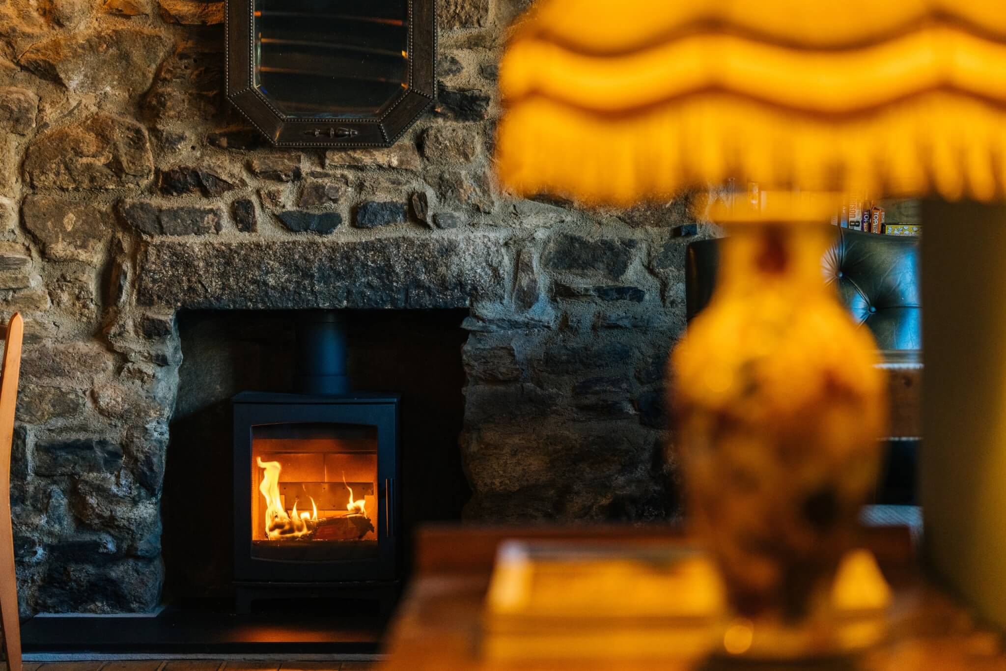 Log burner set in a stone wall at the Red Lion