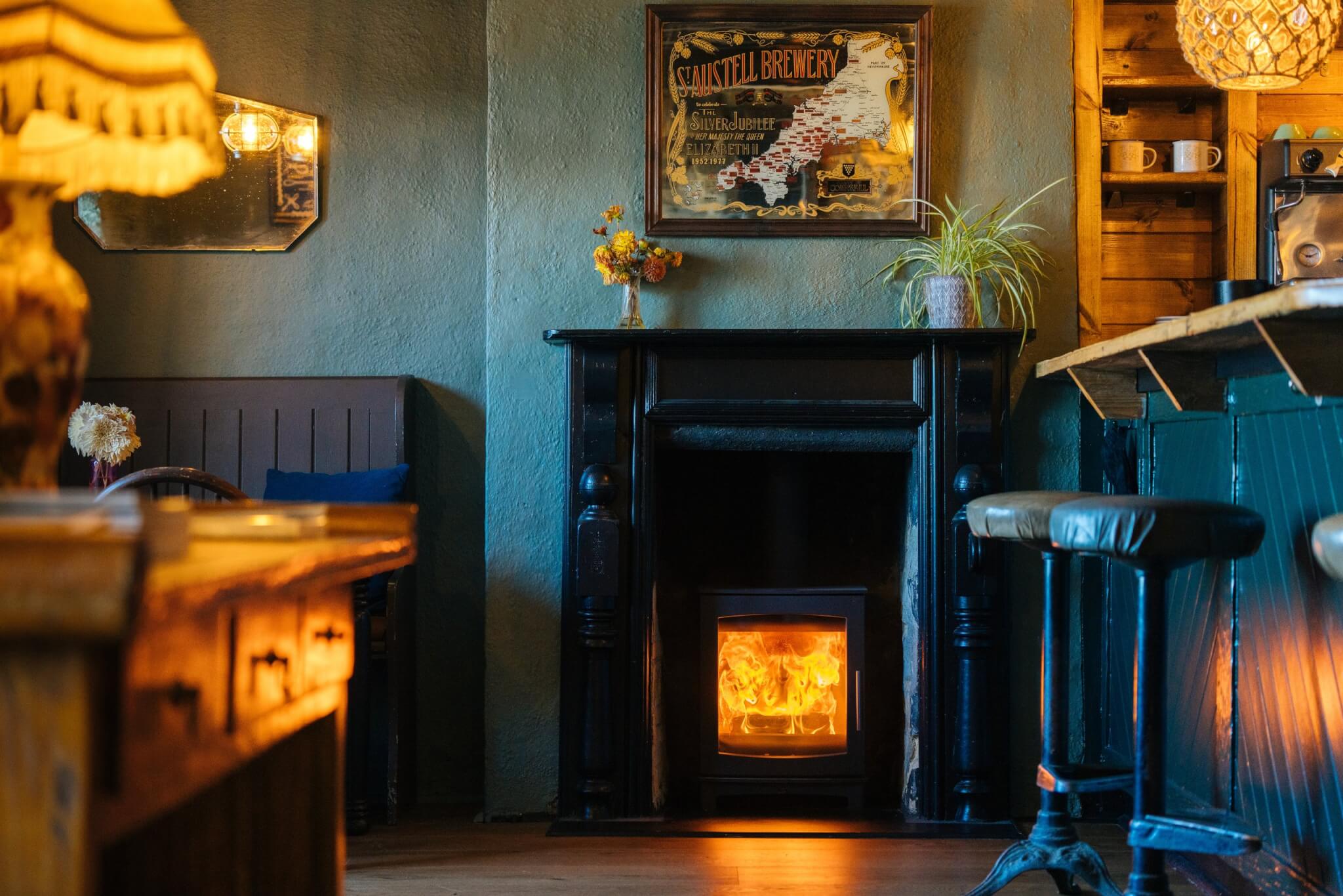 Log burner and bar stools inside the Red Lion in Newlyn