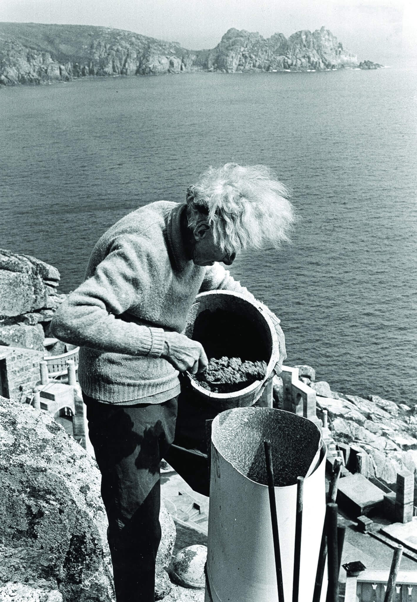 Rowena Cade pouring concrete into a pillar mould high above Porthcurno