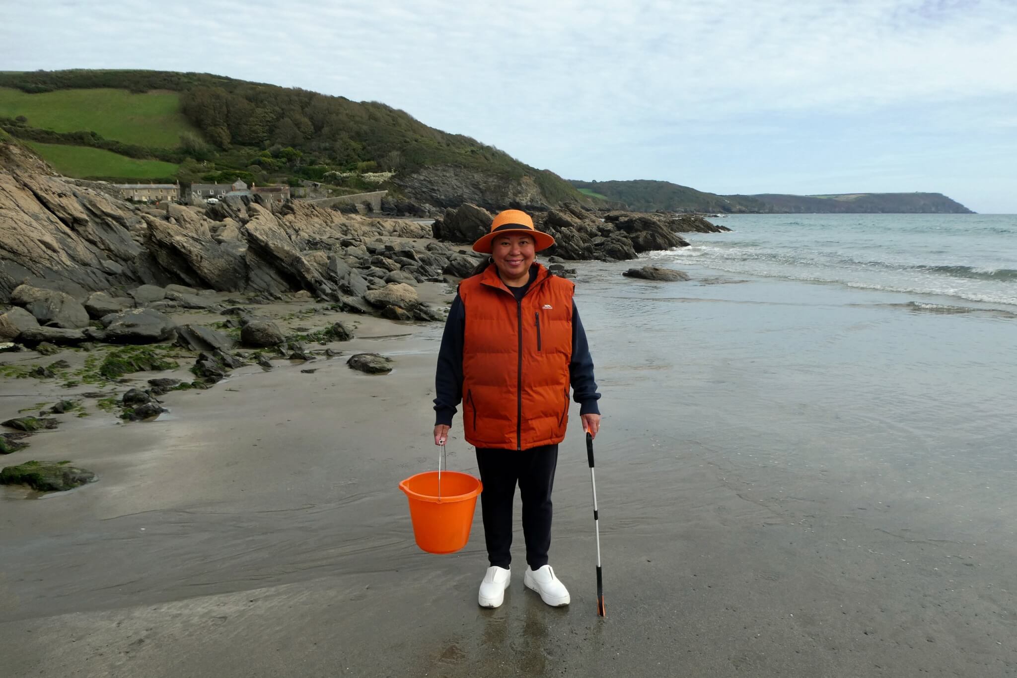 Rowena Castillo-Nicholls with a bucket and litter picker on West Portholland Beach