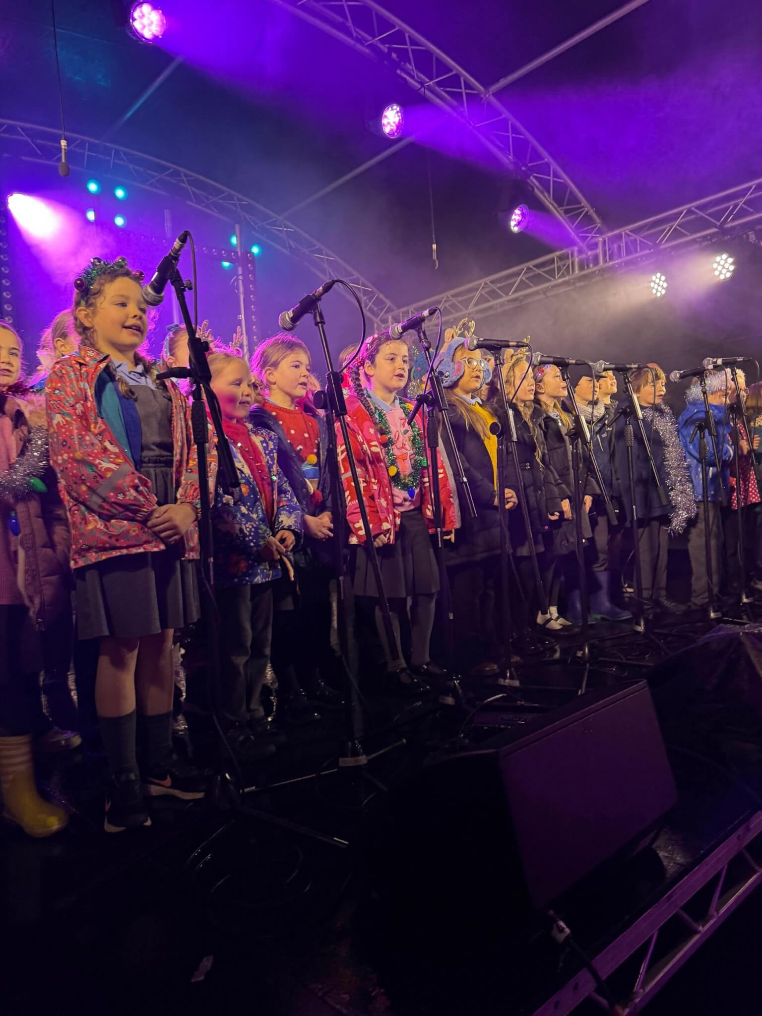 Schoolchildren singing on stage at the Falmouth Christmas lights switch-on