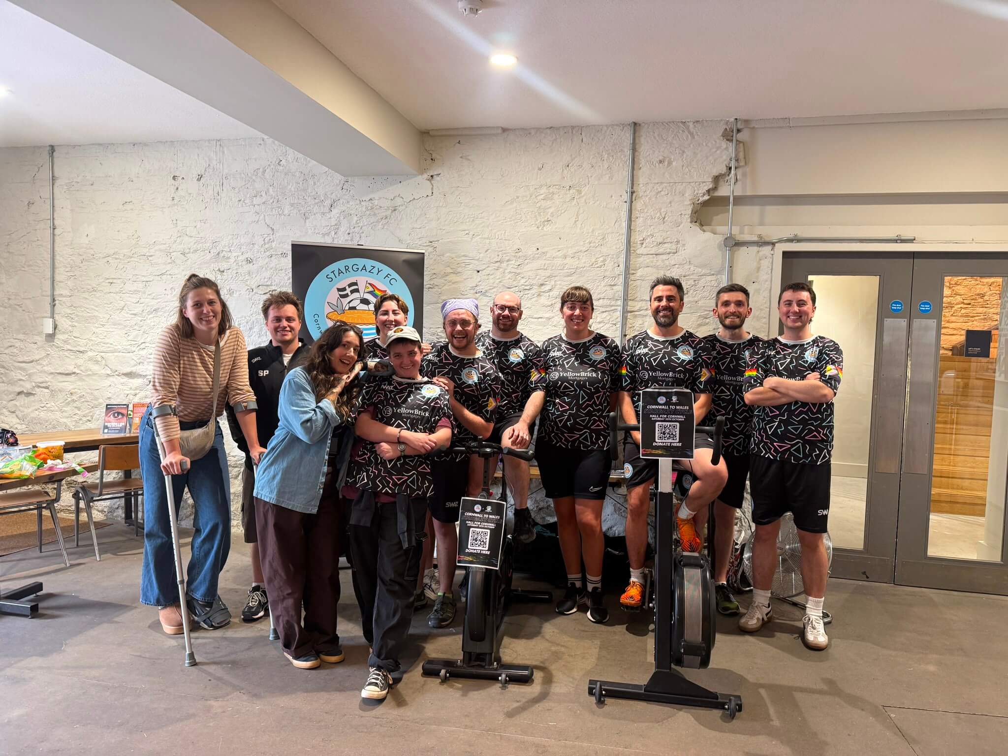 Stargazy FC players and supporters gathered around two exercise bikes at Hall for Cornwall