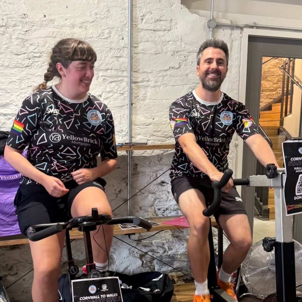Two Stargazy FC players riding exercise bikes