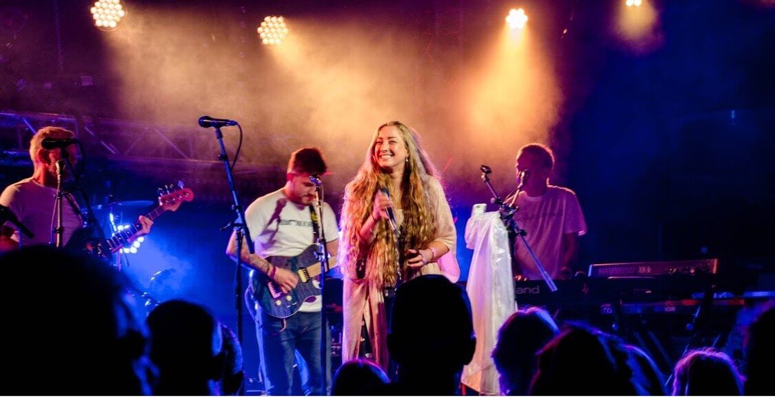 Suzie Mac performing on stage with her band
