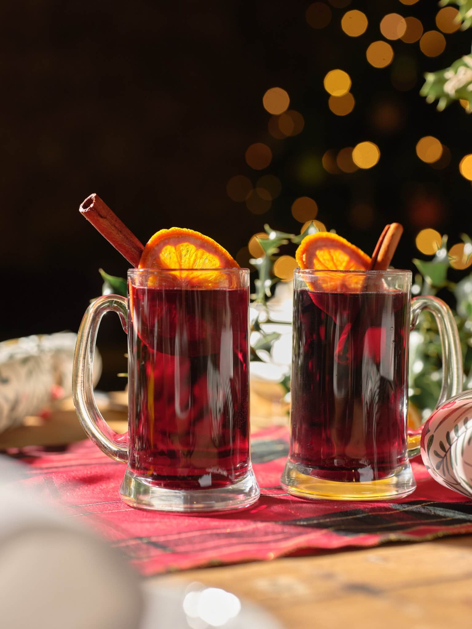 Two glasses of mulled wine with orange and cinnamon