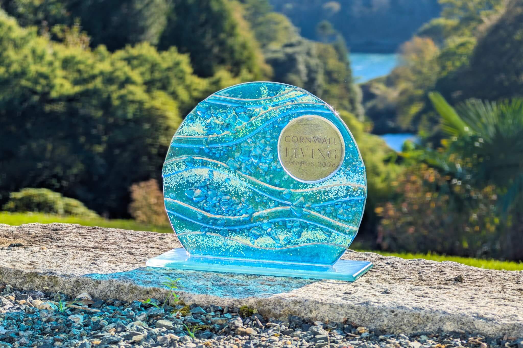 Cornwall Living Awards 2026 glass trophy with Trebah Garden's valley behind
