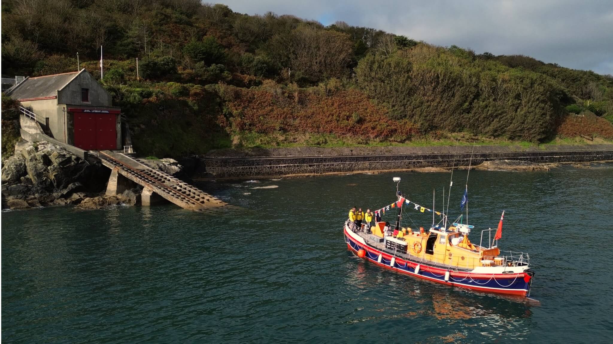 Former RNLI Watson class lifeboat A.M.T. off the old Penlee Point boathouse and slipway