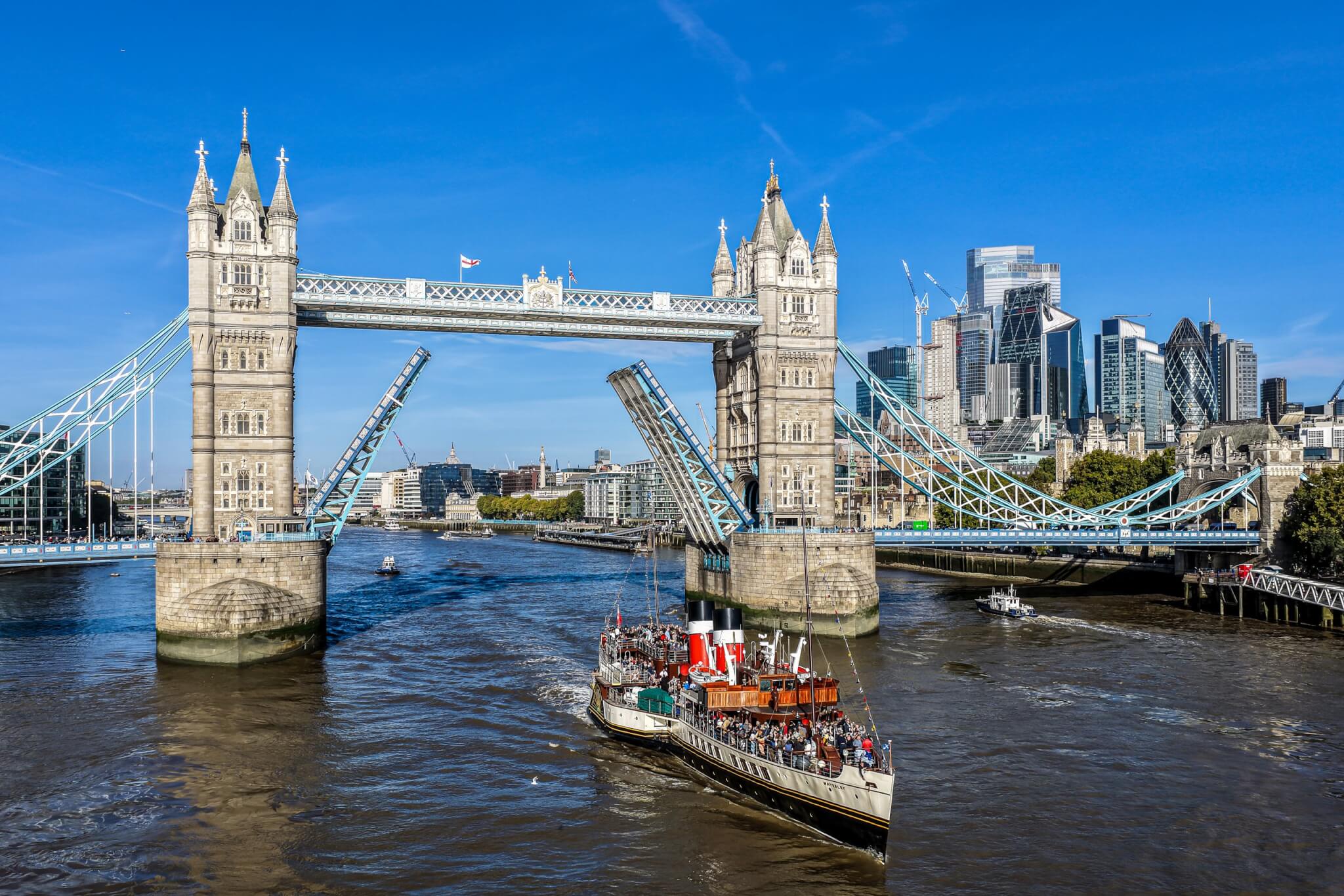 Paddle Steamer Waverley passing through the raised Tower Bridge in London