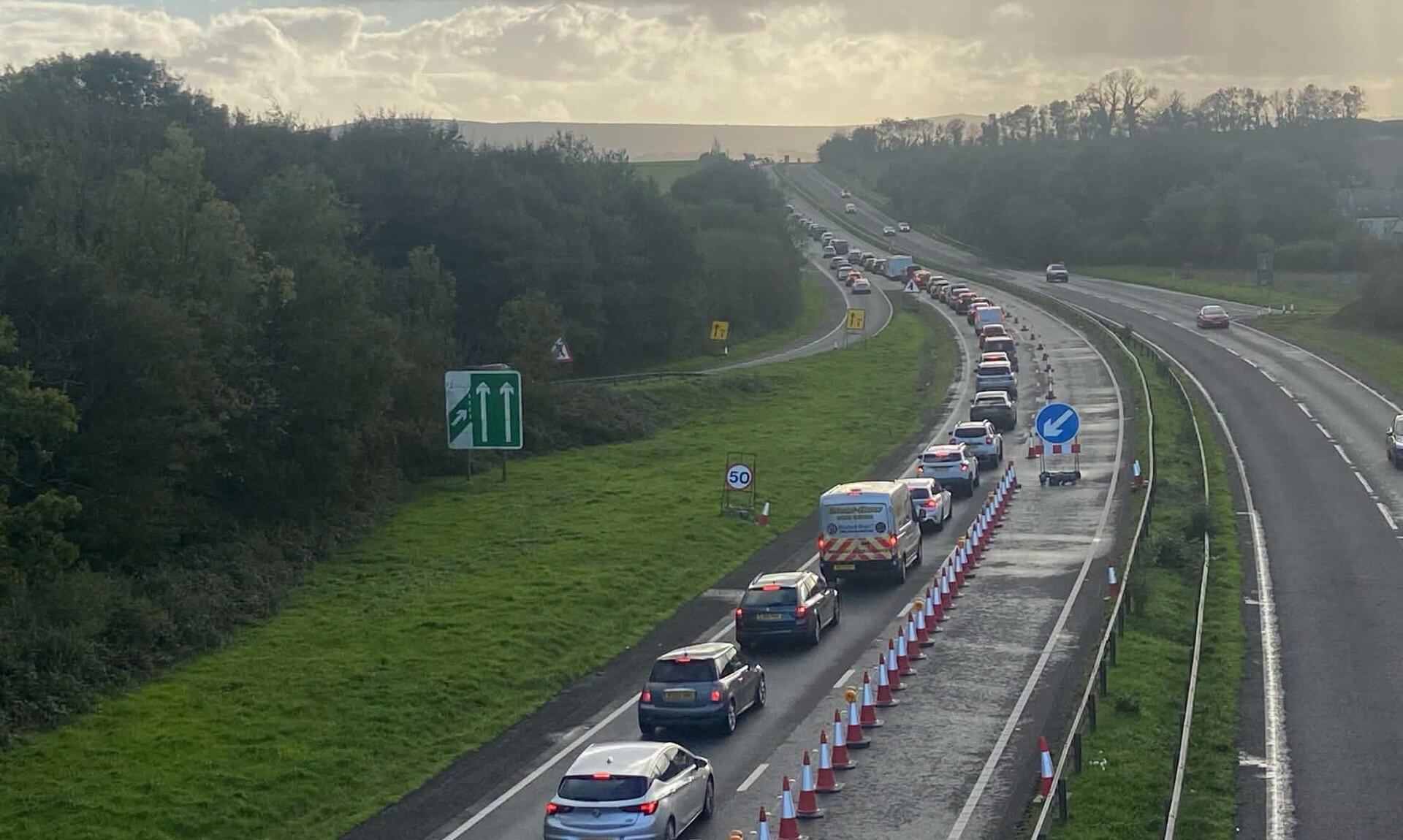 Queue of traffic in a single coned-off lane on the A30 during safety roadworks