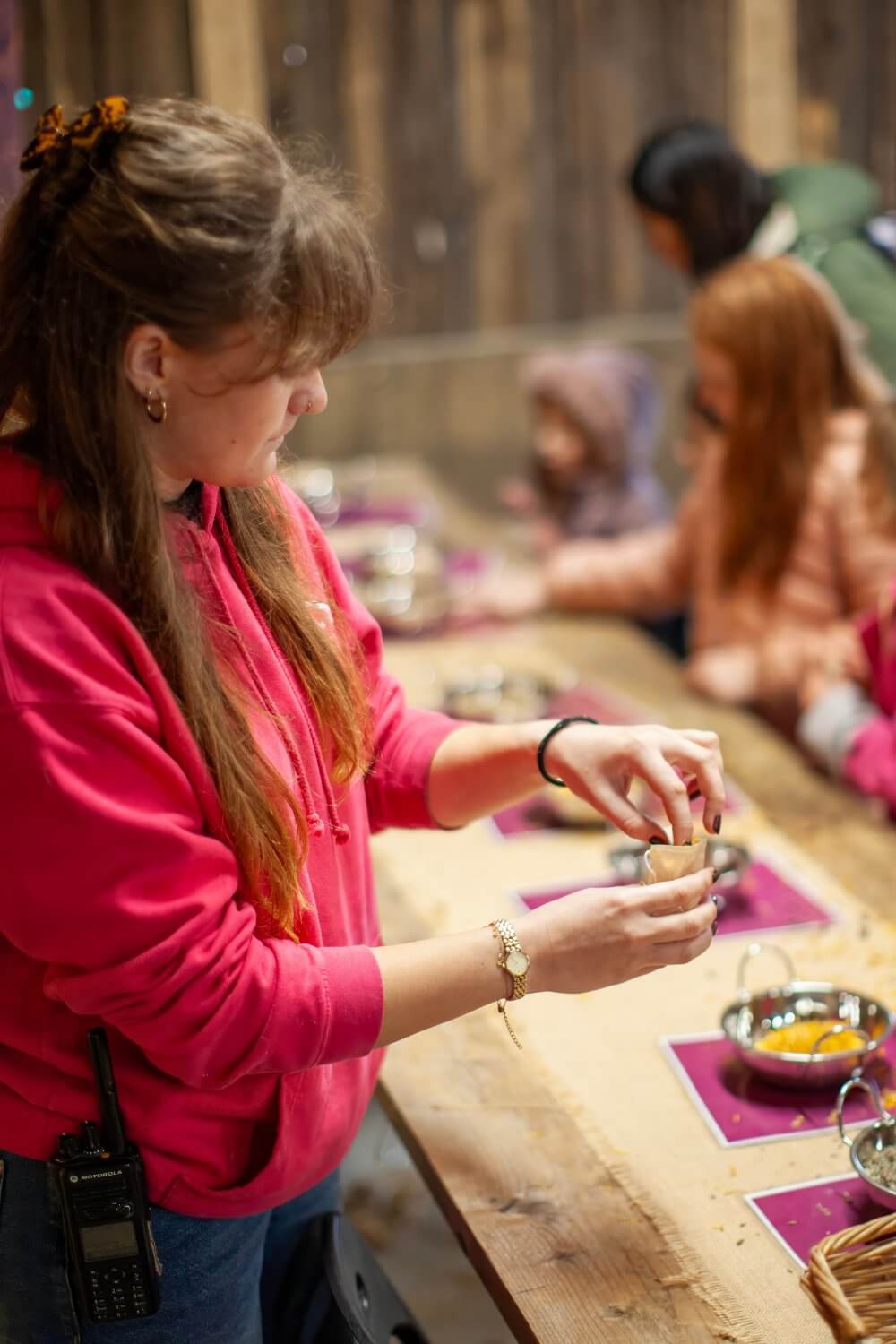Woman at a craft table during a Halloween activity session