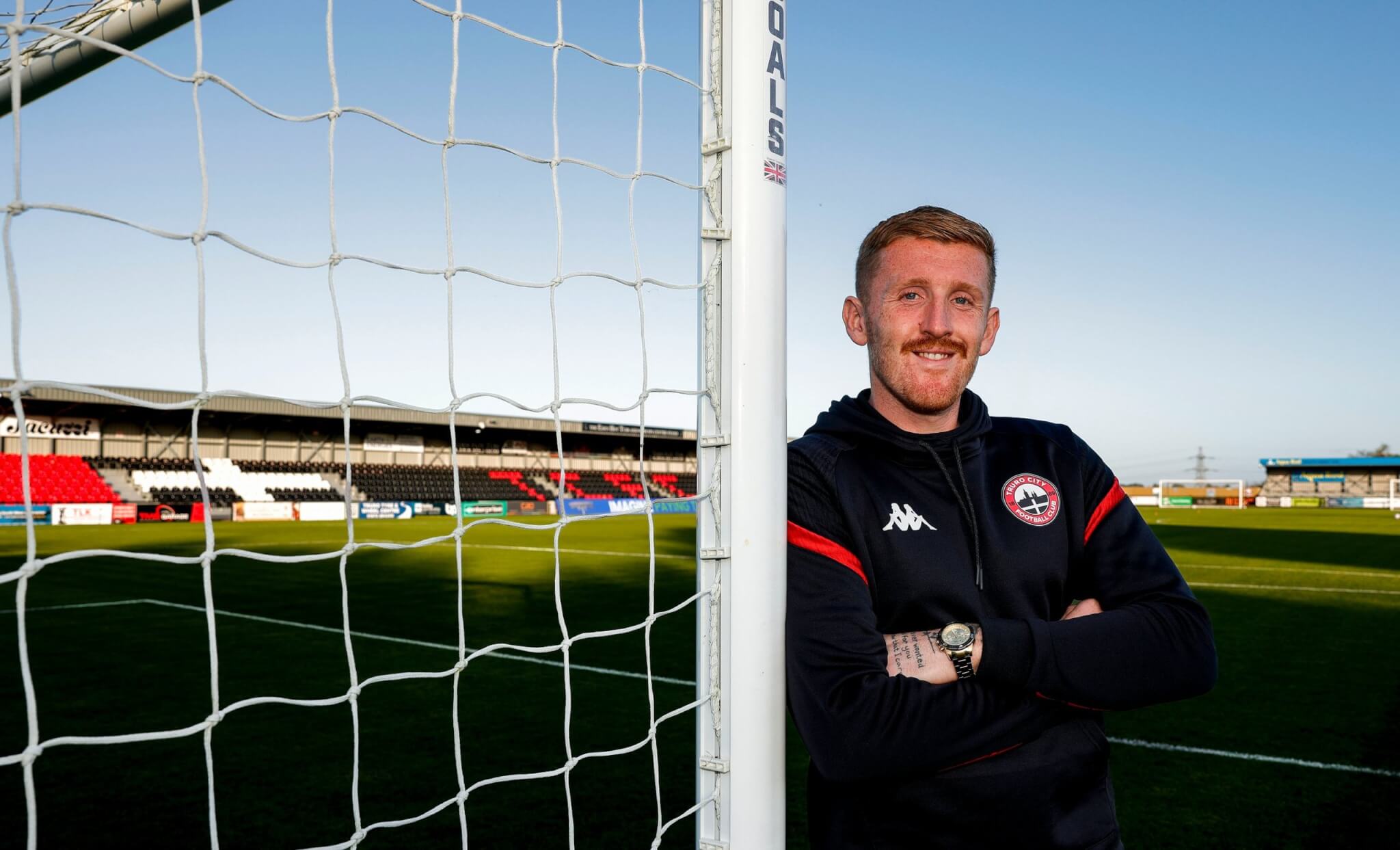 Truro City goalkeeper Aidan Stone leaning on a goalpost at Truro City Stadium