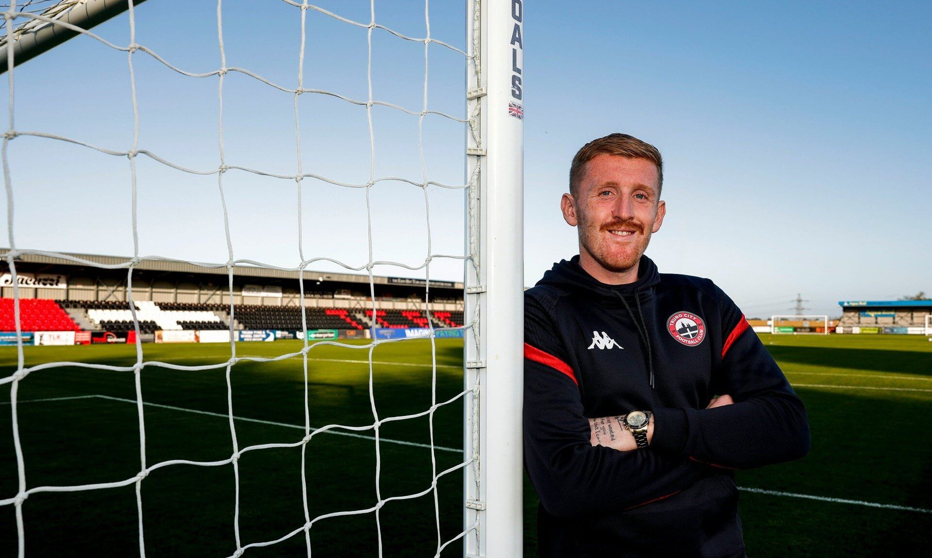 Truro City goalkeeper Aidan Stone leaning on a goalpost at Truro City Stadium