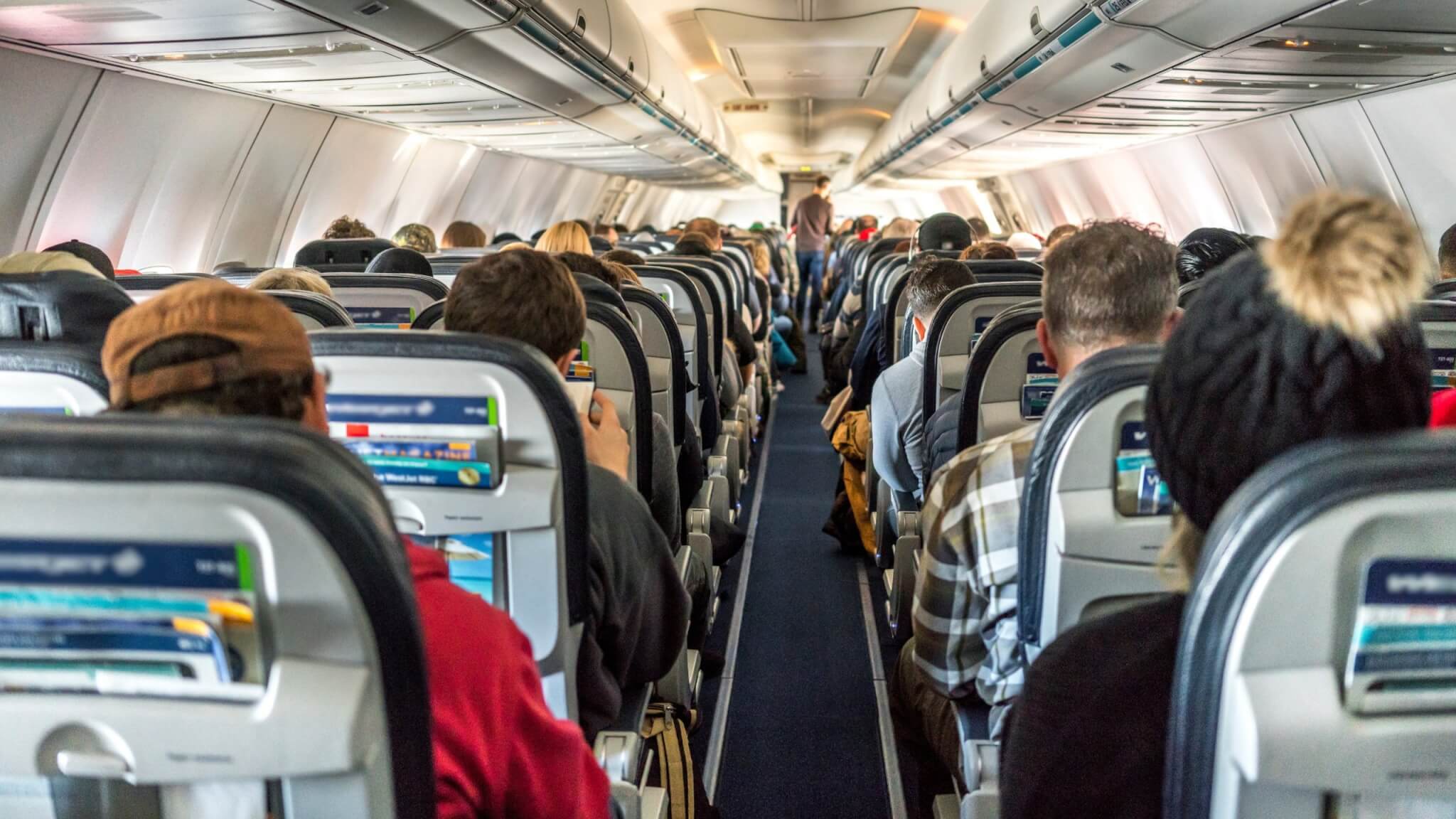 Passengers seated in an aircraft cabin