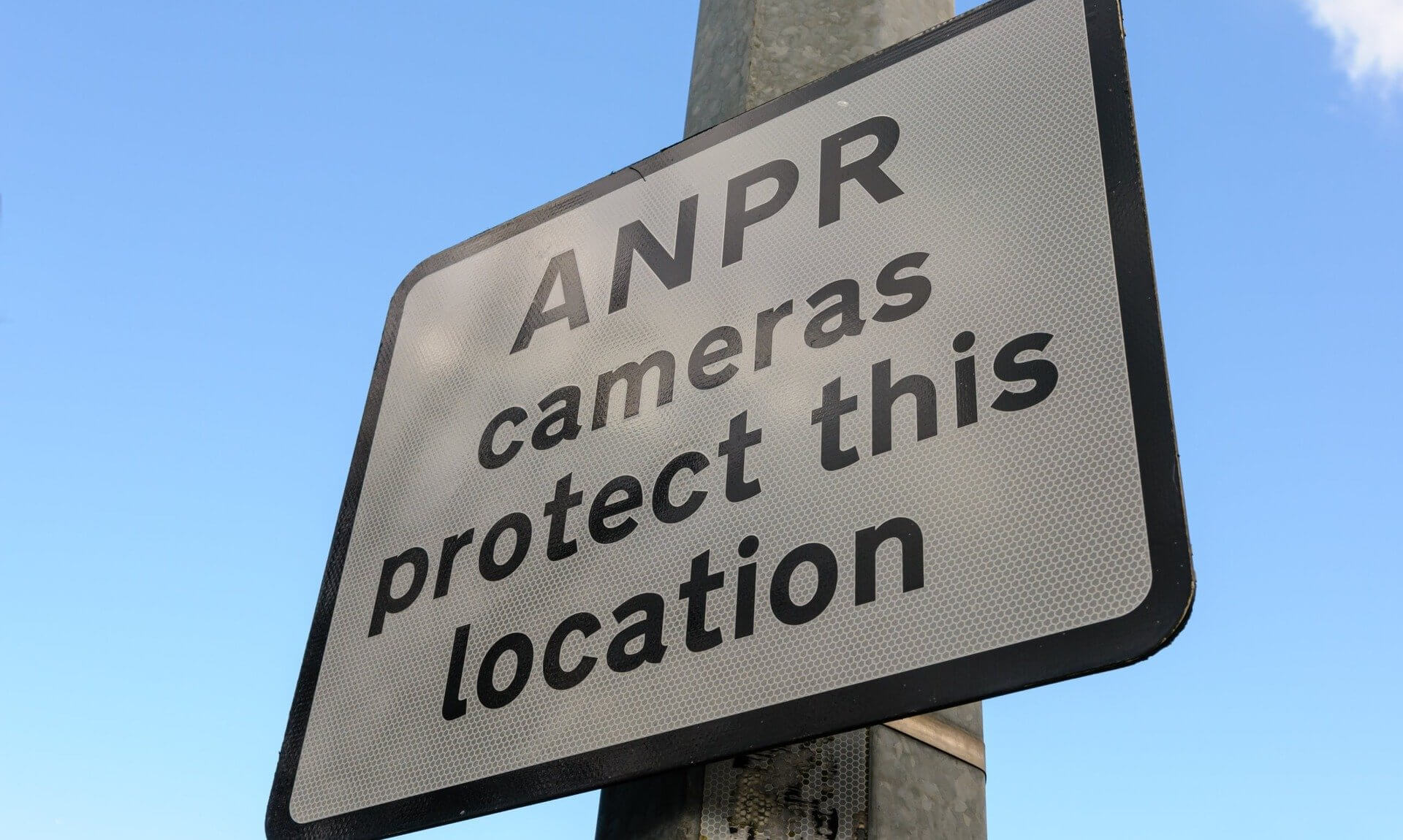 Sign reading ANPR cameras protect this location on a lamp post