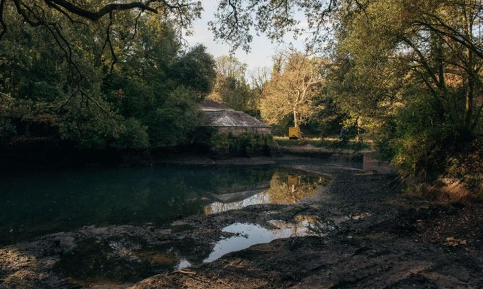 The Bath House beside the low, muddy swimming pond on the Antony Estate