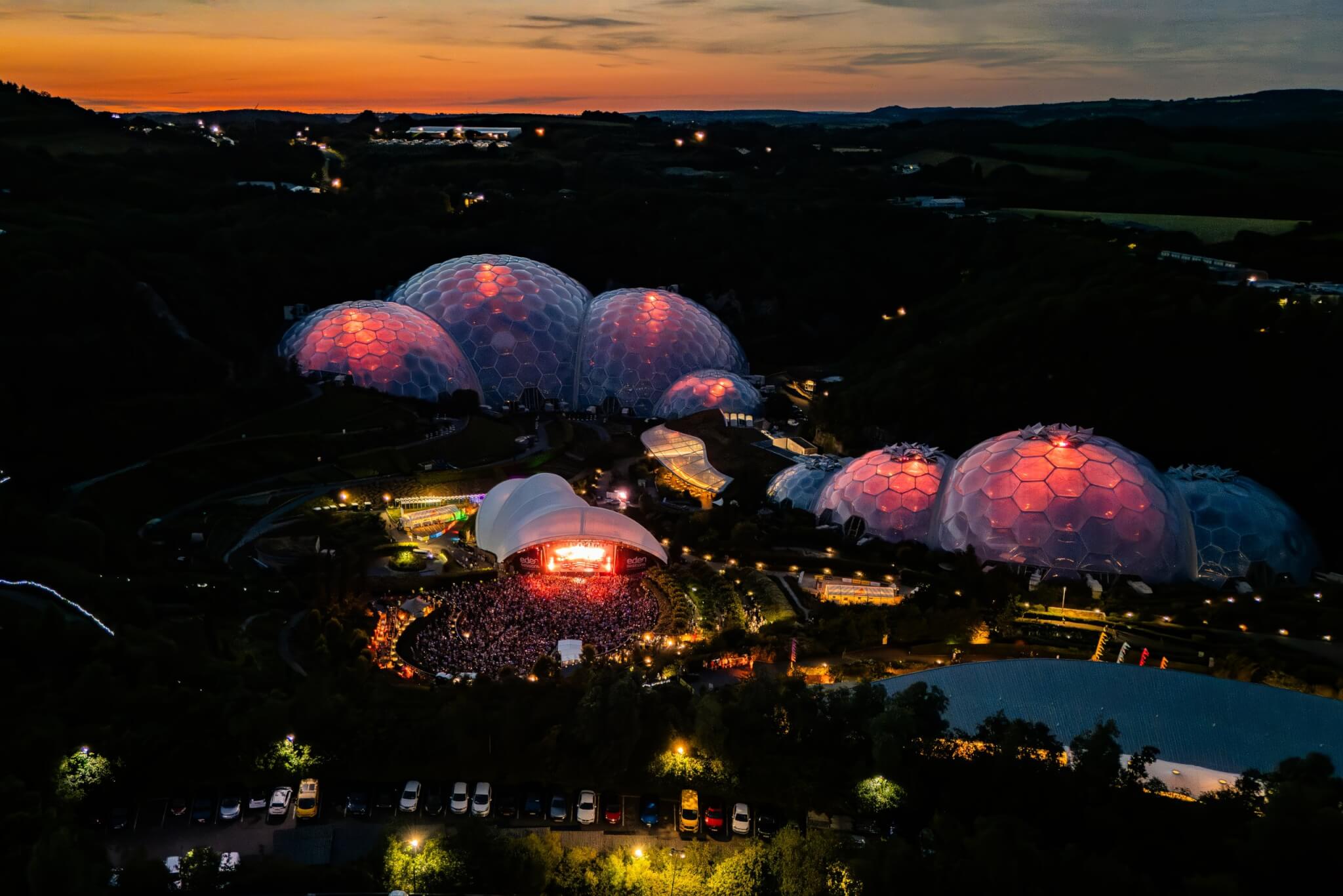 Biomes glowing at sunset above the Eden Sessions arena