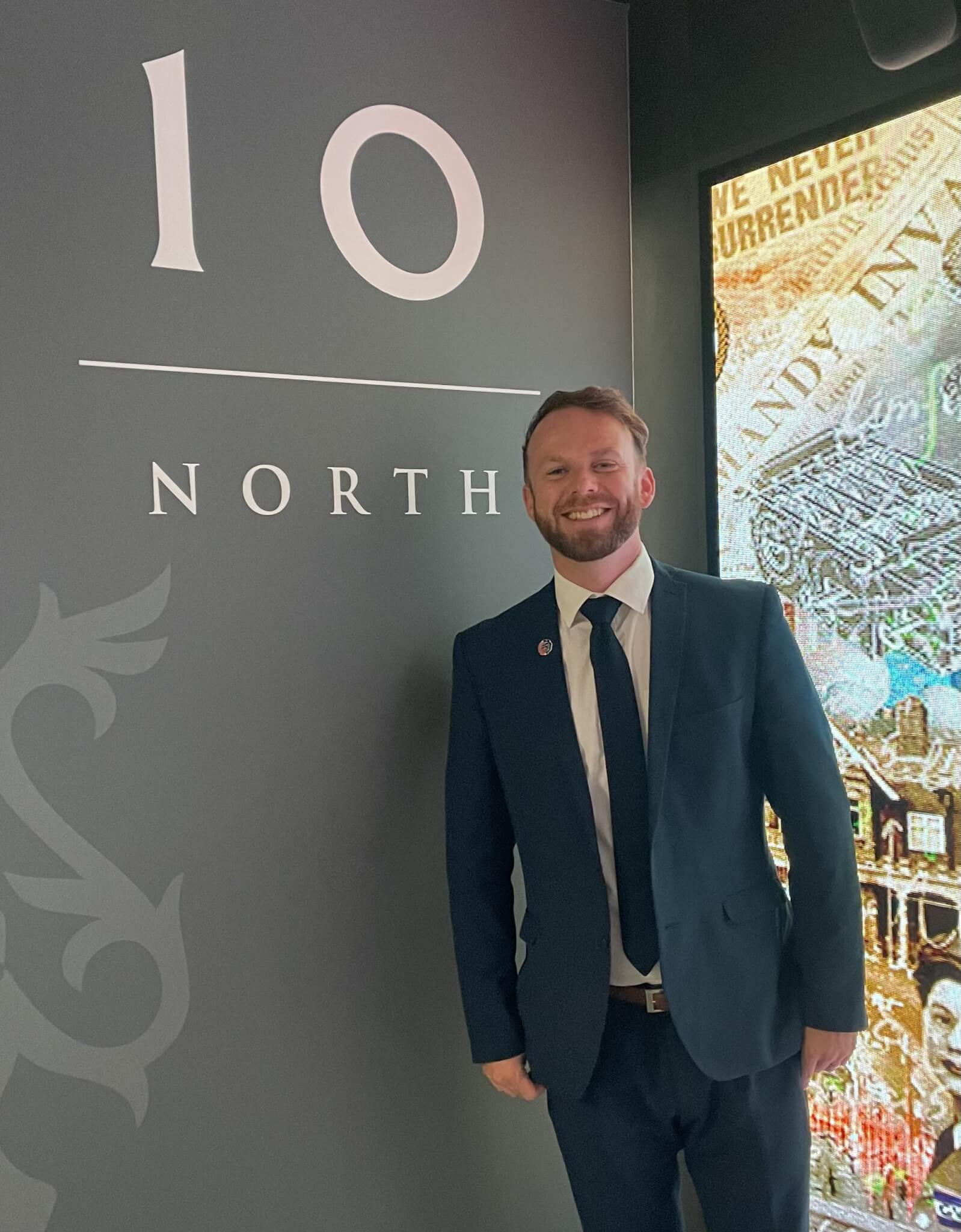 North Cornwall MP Ben Maguire standing beside the 10 North sign