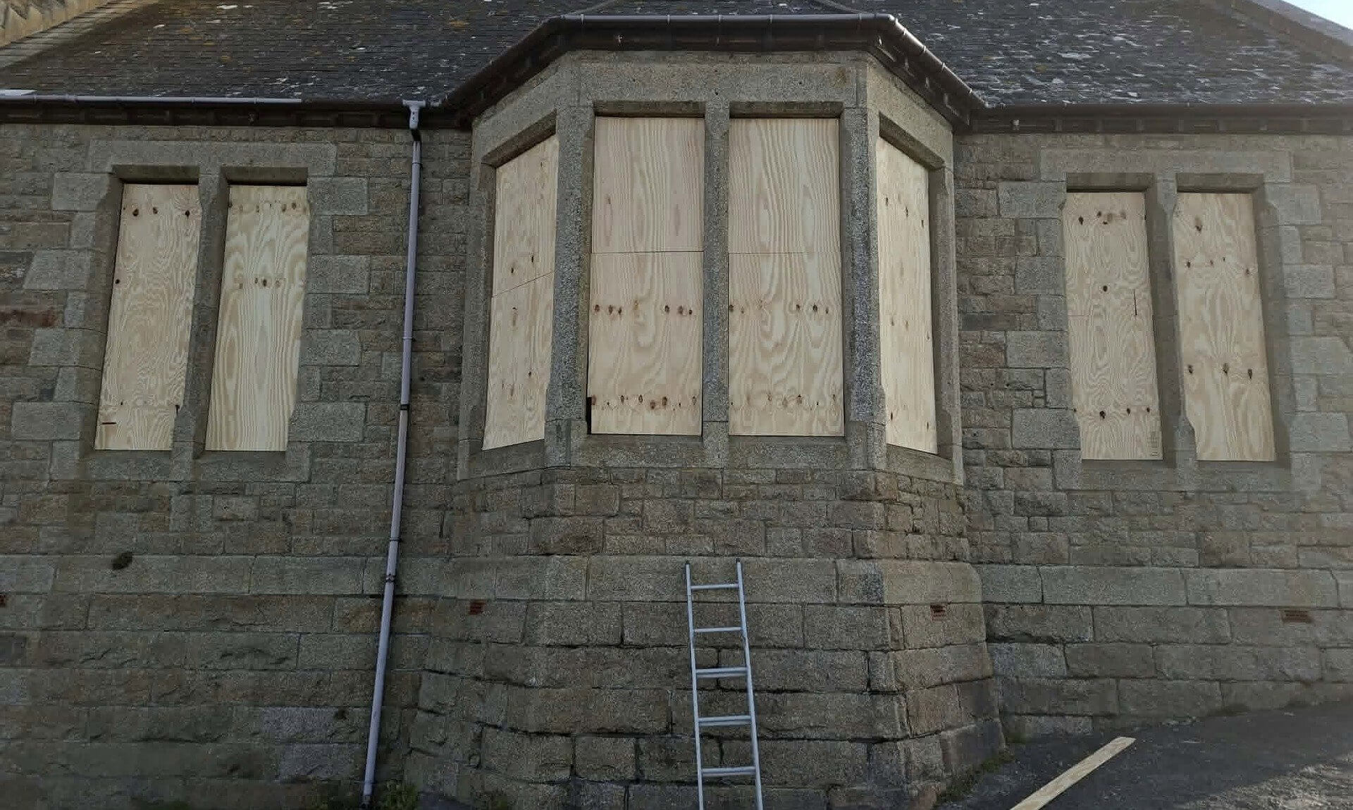 Boarded-up windows on the granite Bickford Smith Institute in Porthleven