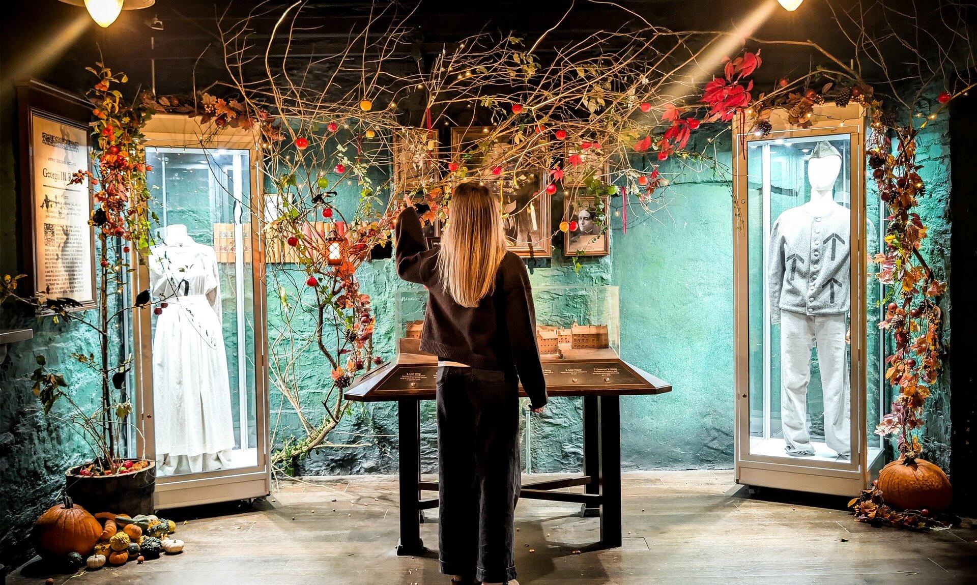 Visitor exploring a Halloween-decorated gallery at Bodmin Jail