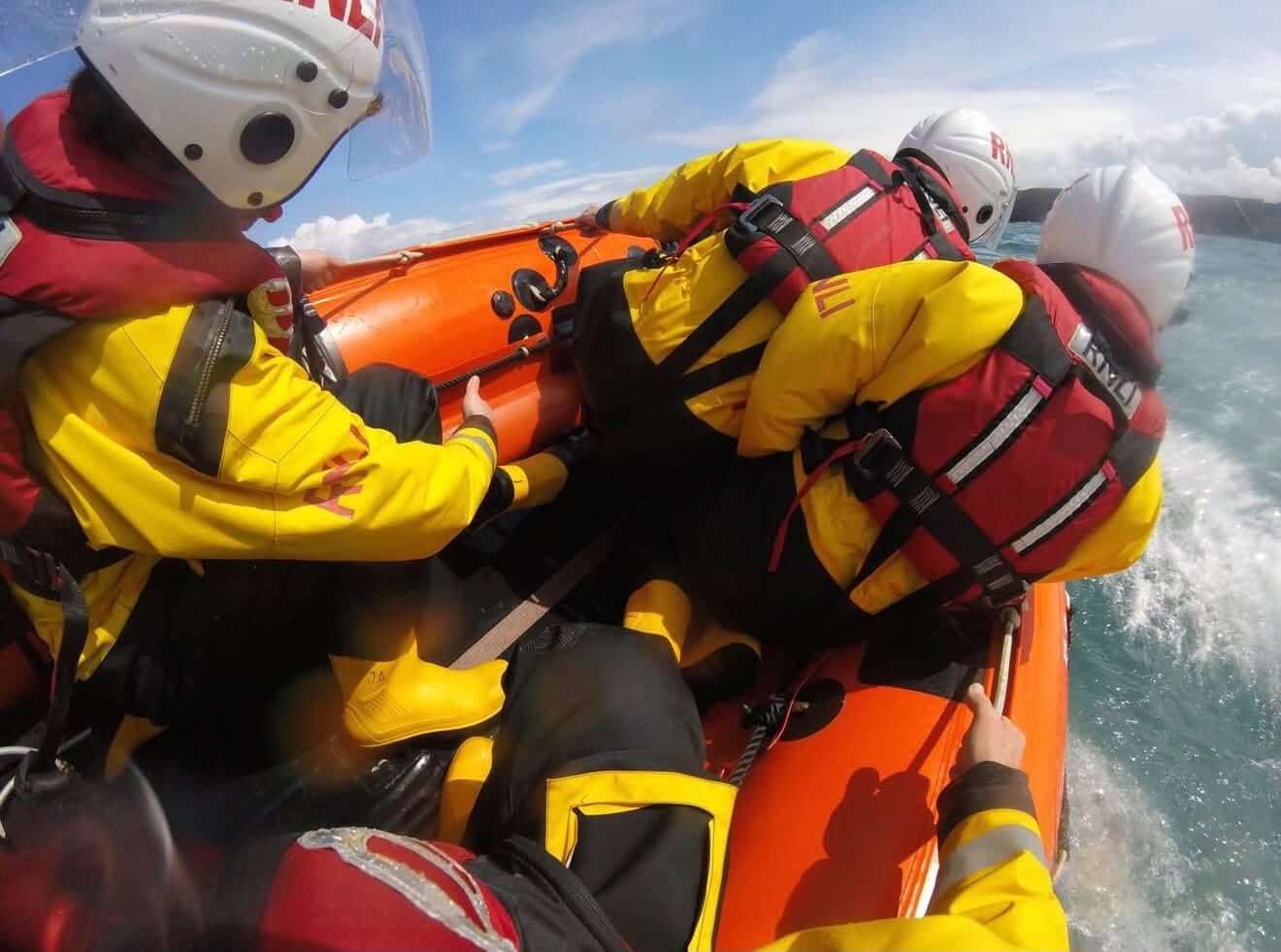 RNLI volunteer crew aboard an inshore lifeboat at sea