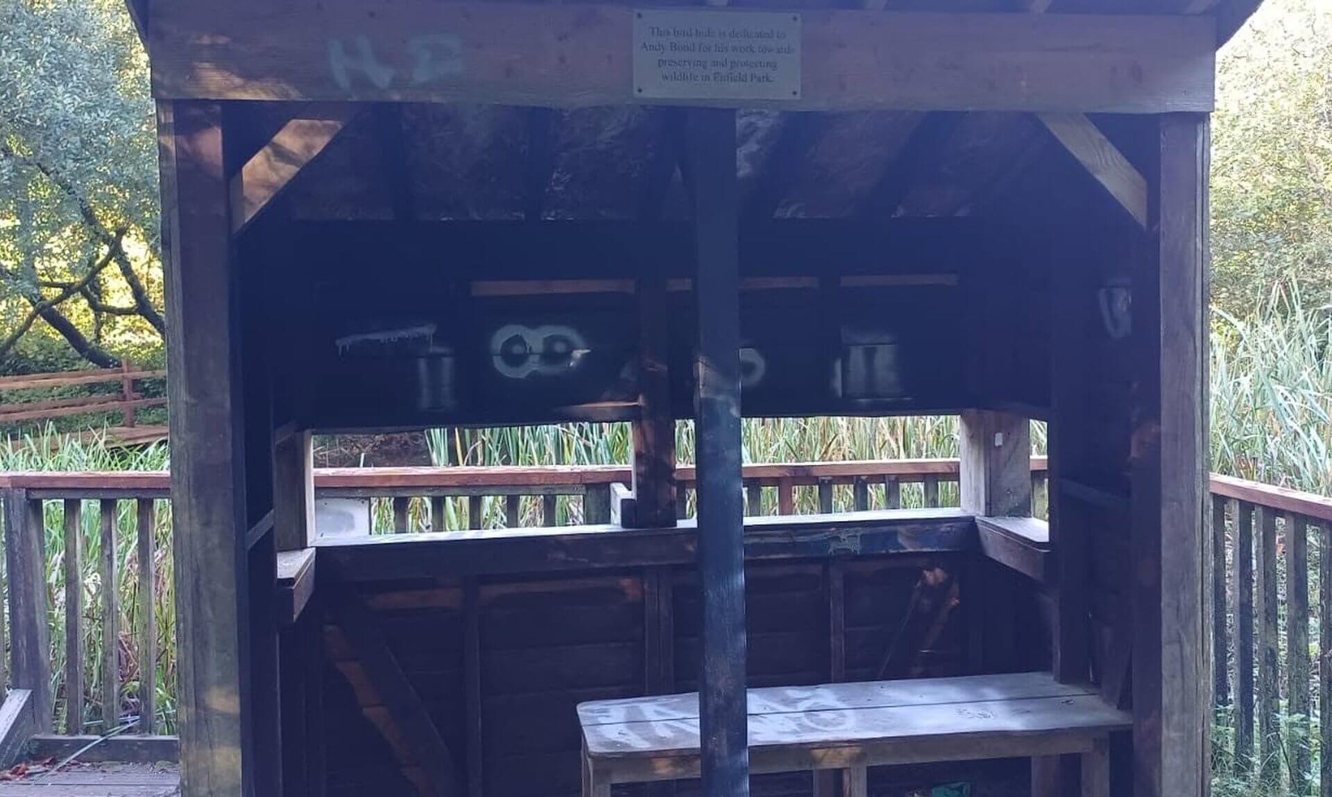 Graffiti inside the wooden bird hide beside the pond in Camelford