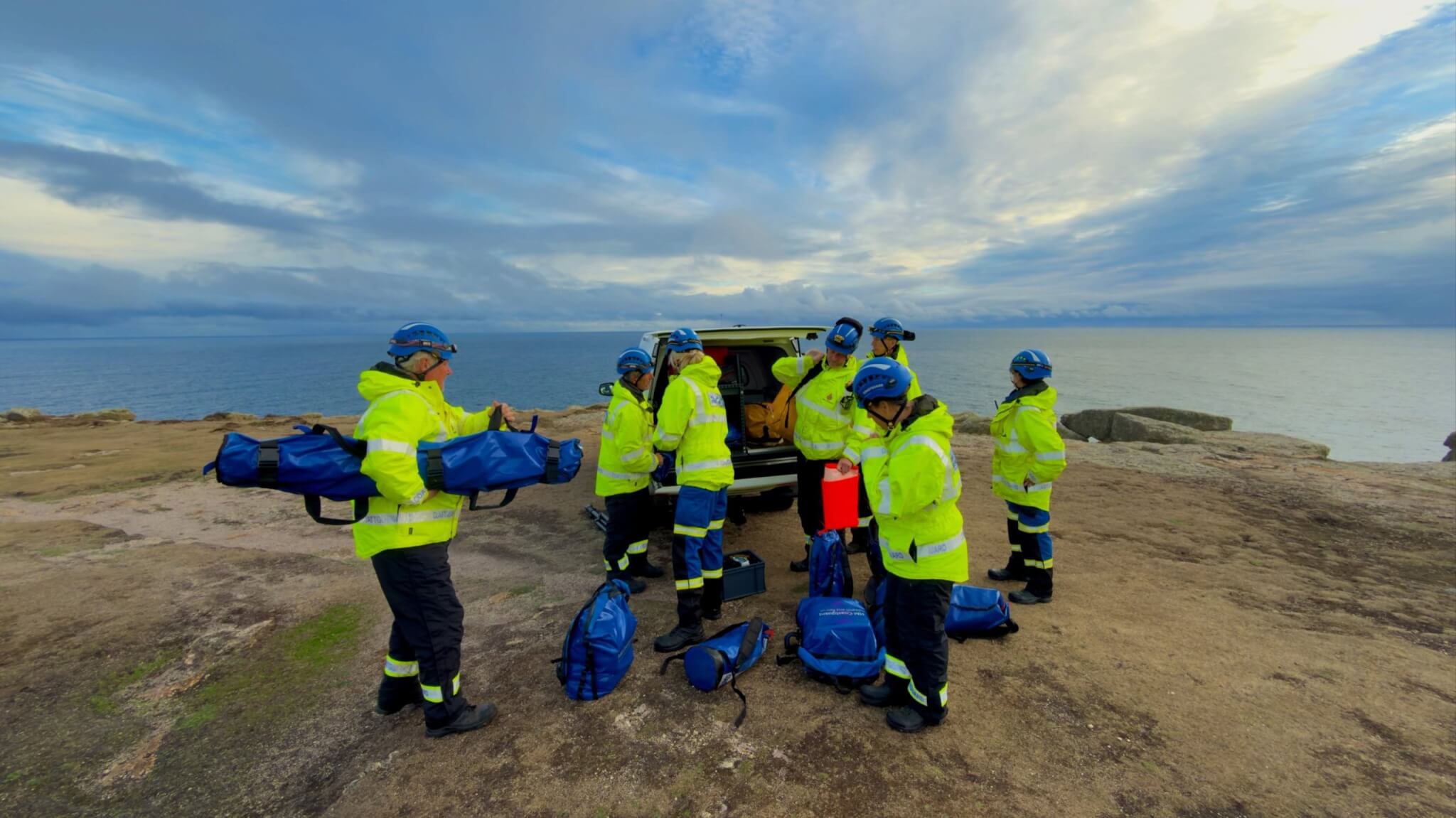 Land's End Coastguard Search and Rescue Team unloading kit from their vehicle on a clifftop