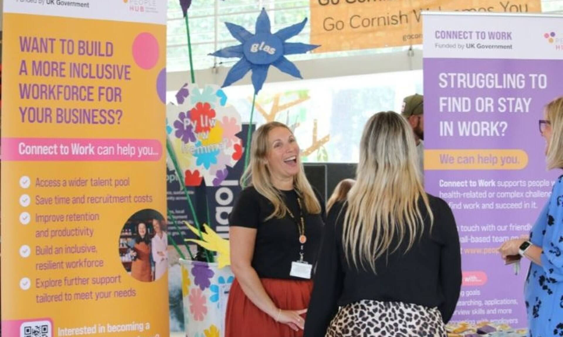 People Hub staff talking to visitors at a Connect to Work stand