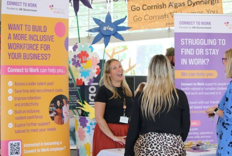 People Hub staff talking to visitors at a Connect to Work stand