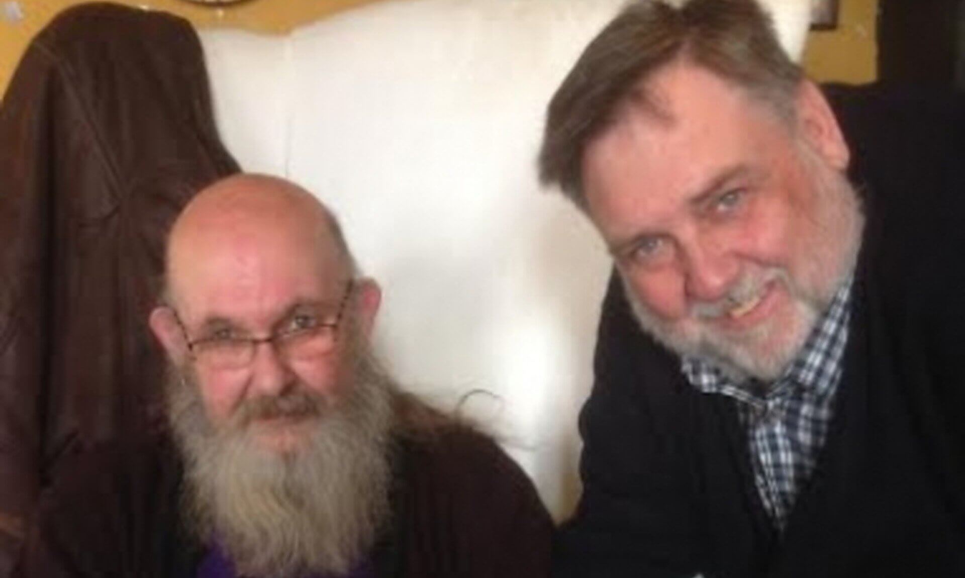 Two men looking at a book together, from the Cornish with Clive podcast