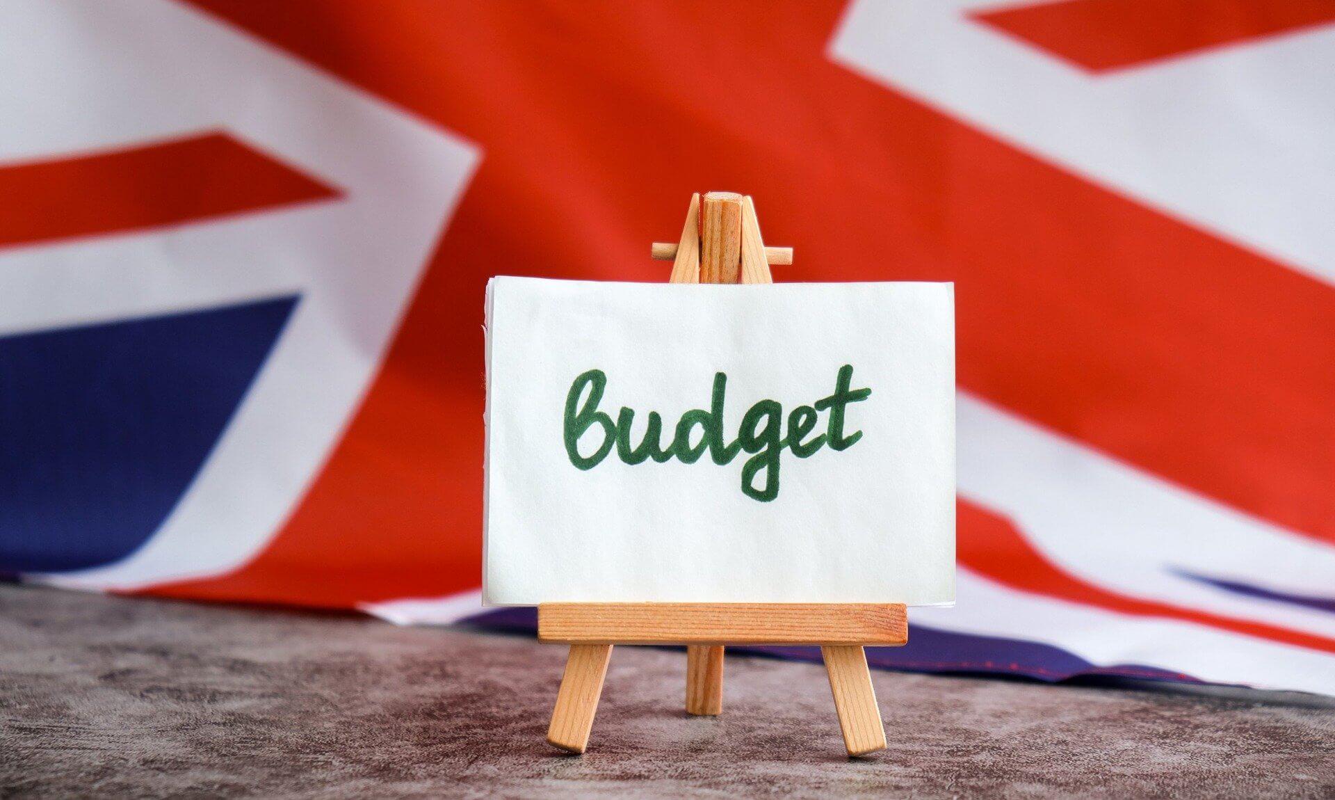 A Budget sign on a small easel in front of a Union flag