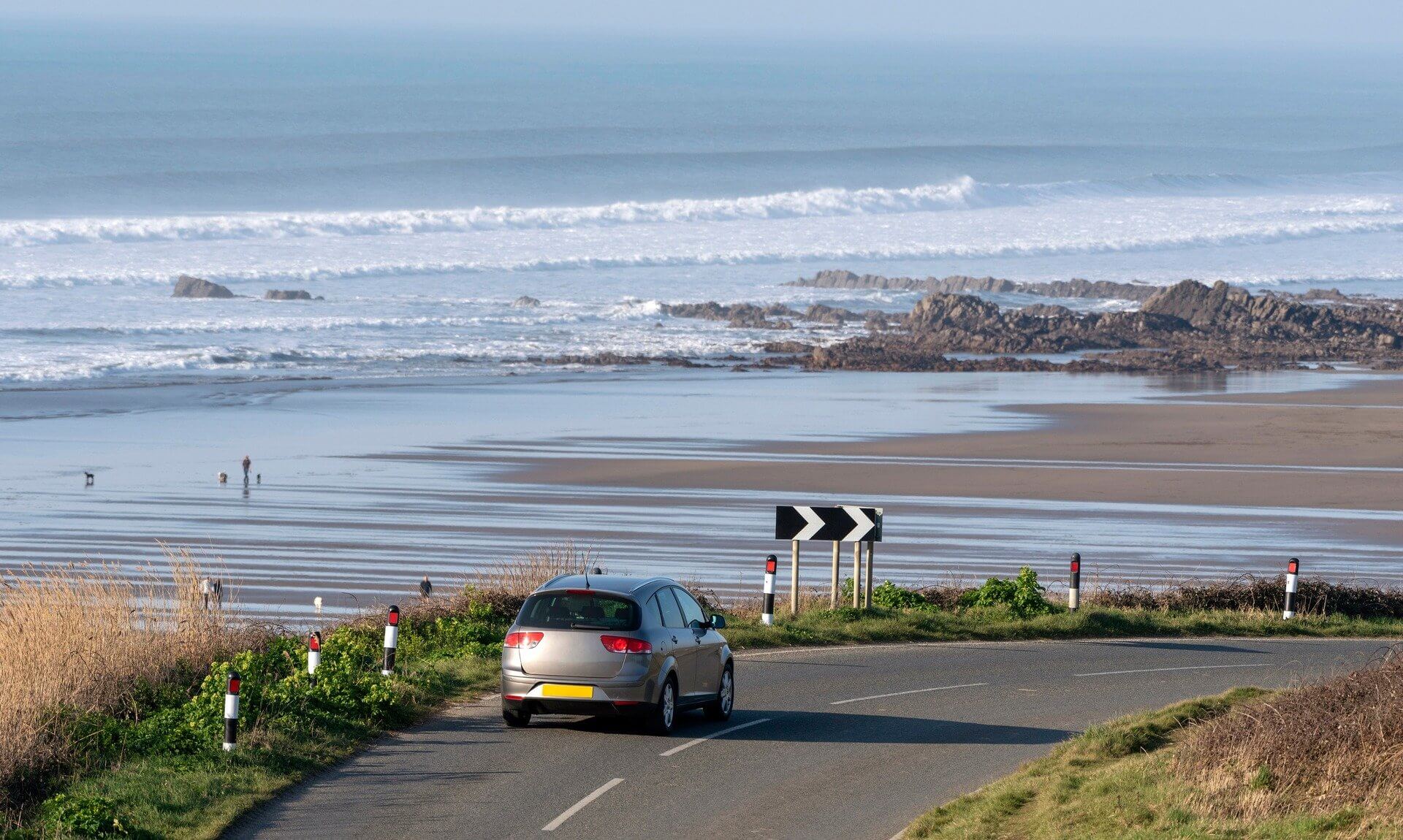 Car on a coastal road above Widemouth Bay in north Cornwall