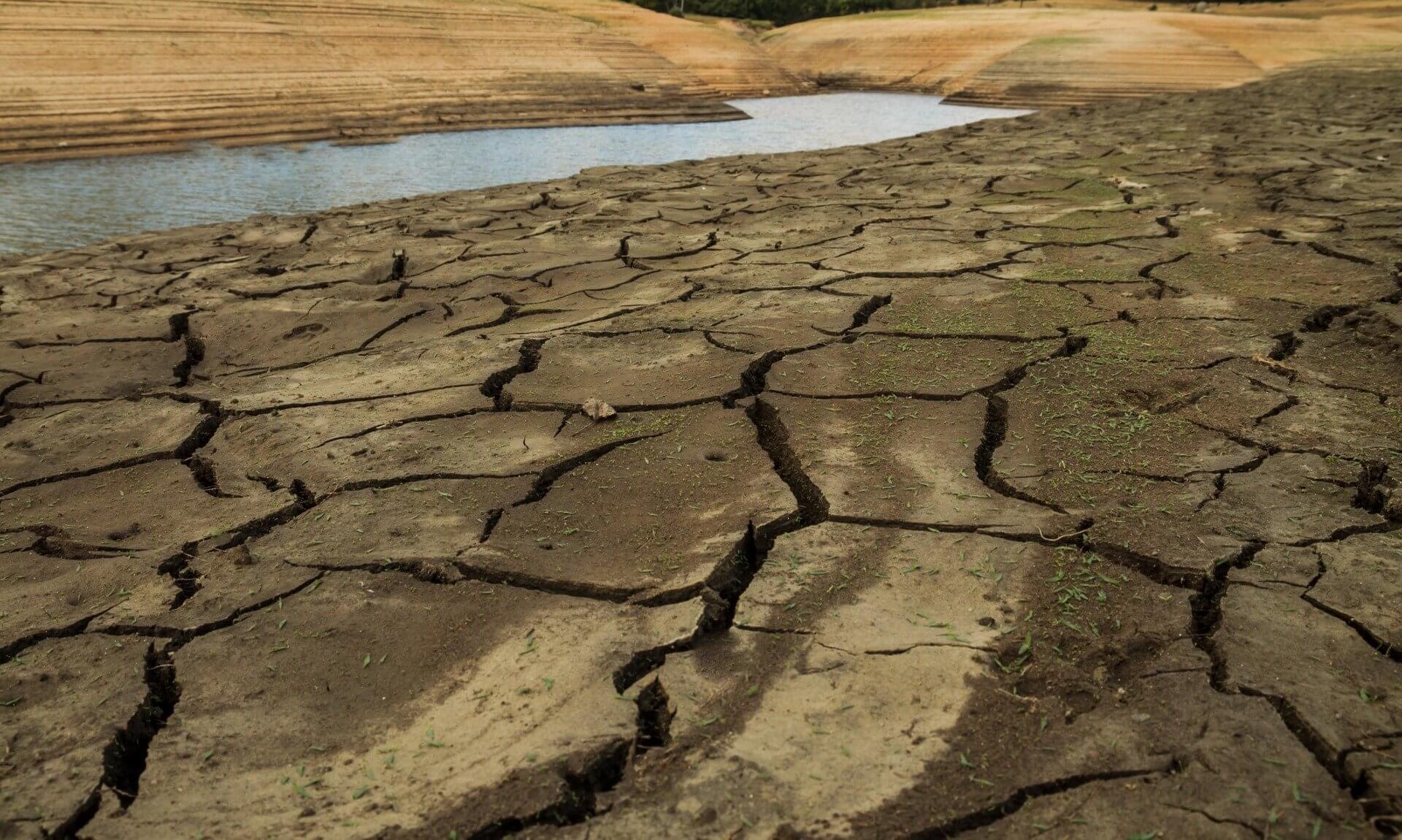 Cracked mud on the exposed bed of a drought-hit reservoir