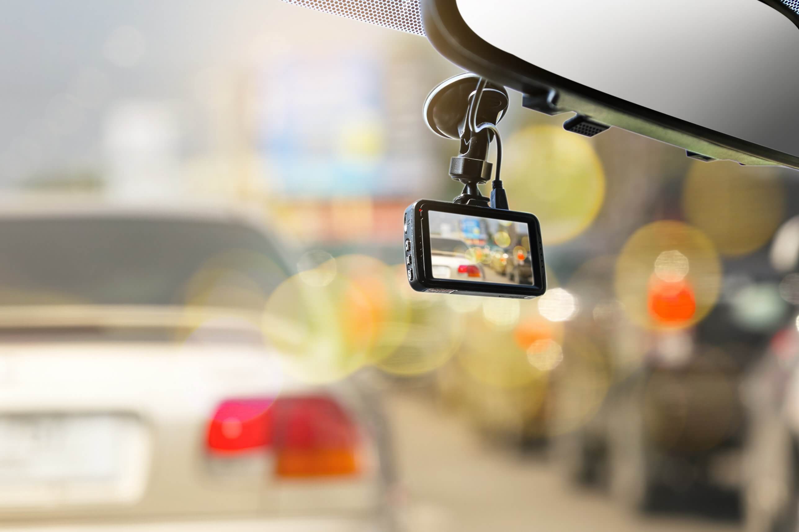 Dash-cam mounted on a car windscreen in traffic