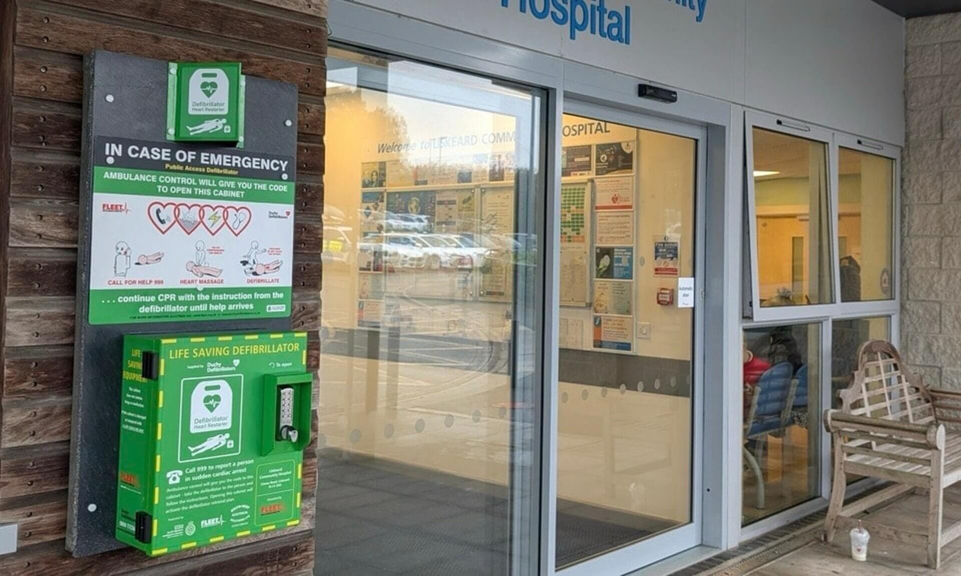 Public access defibrillator cabinet beside the entrance of Liskeard Community Hospital