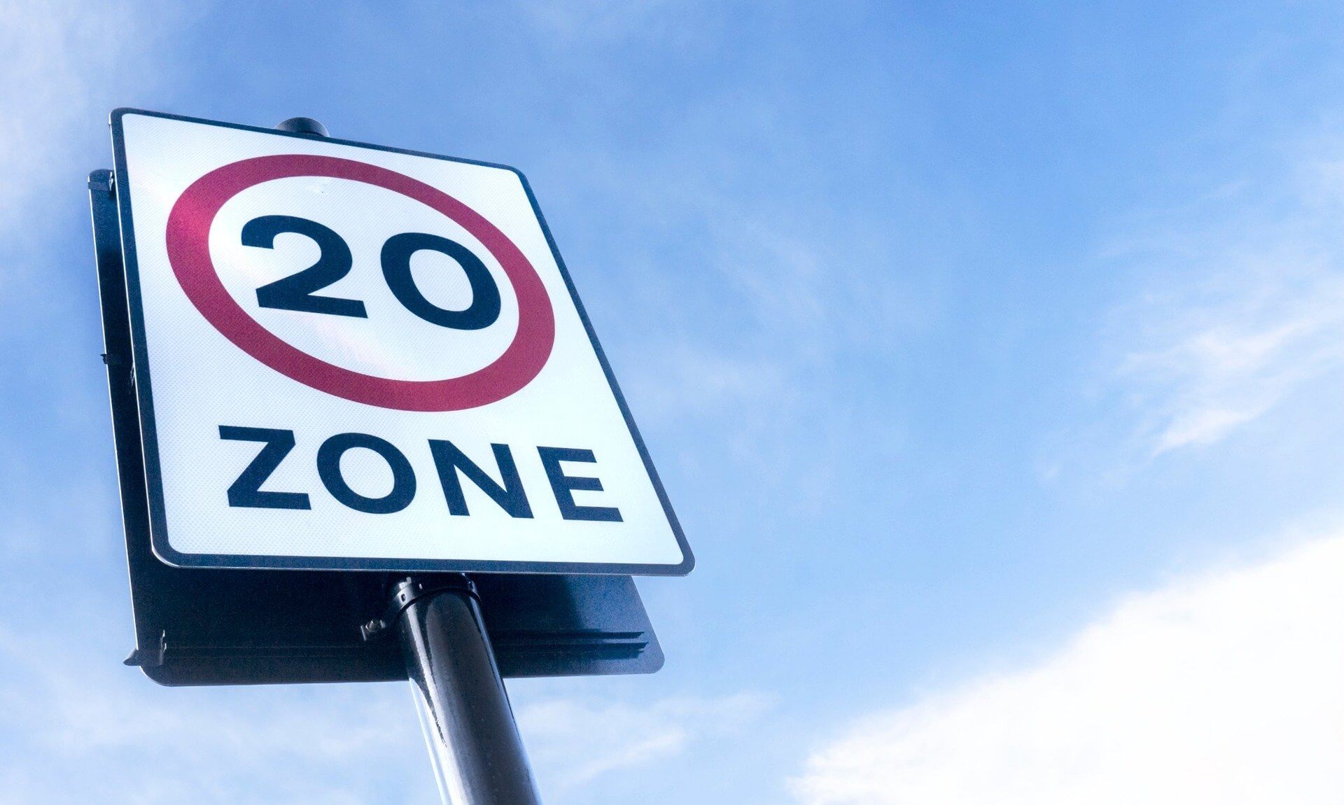 20mph zone speed limit sign against a blue sky