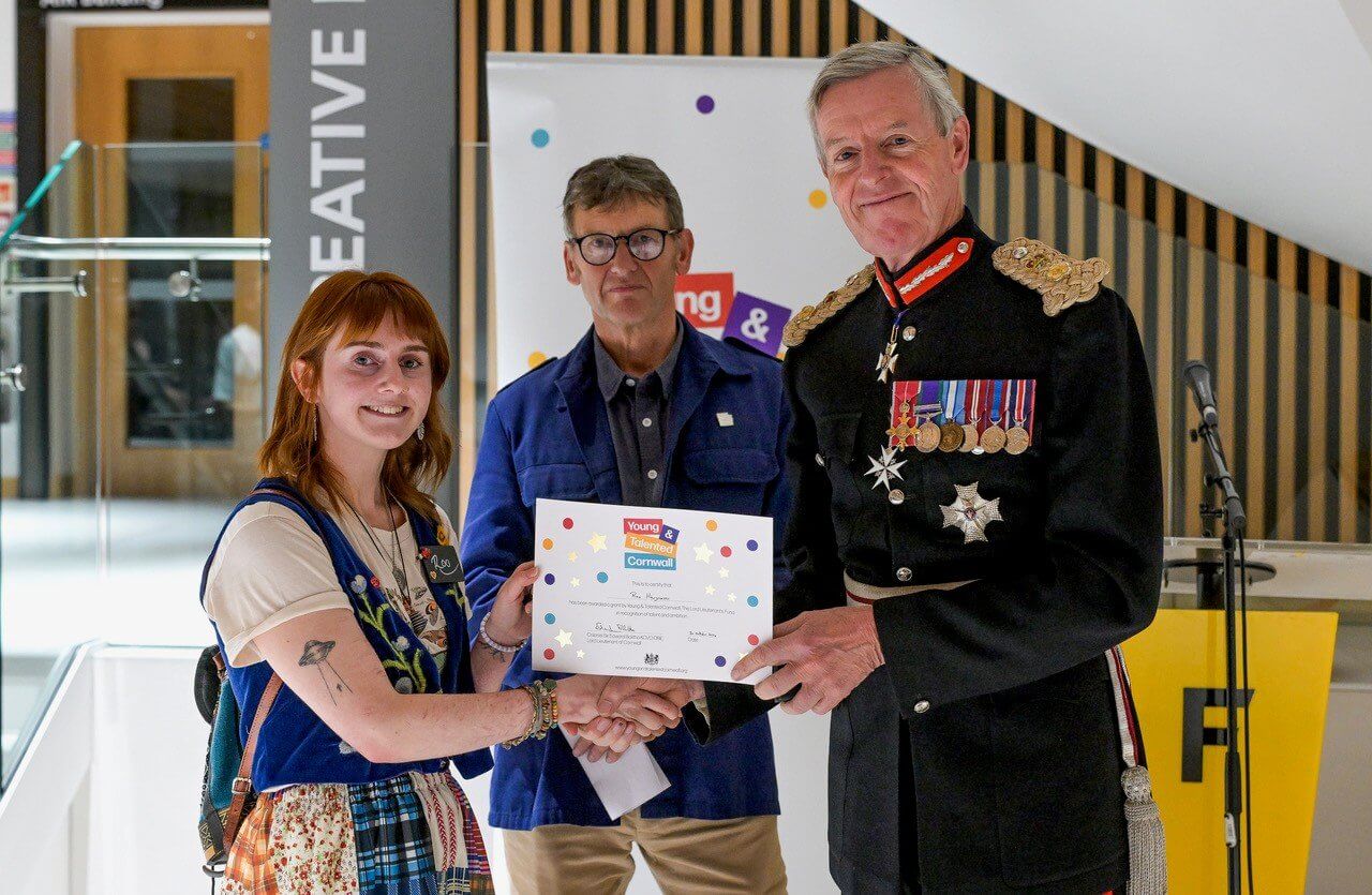 An award winner receiving a certificate from the Lord Lieutenant of Cornwall